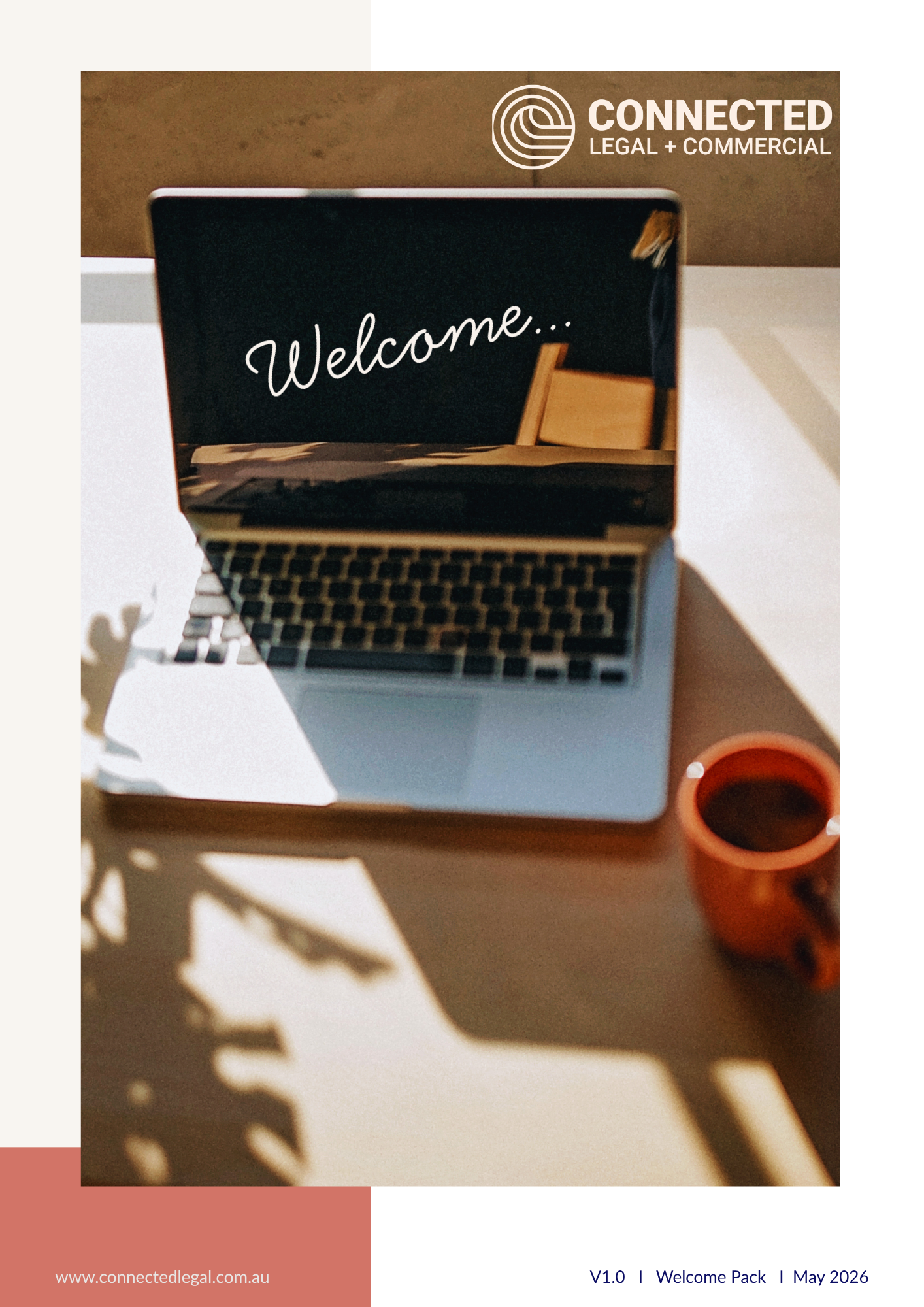 Laptop displaying welcome message on screen with coffee, warm workspace tones