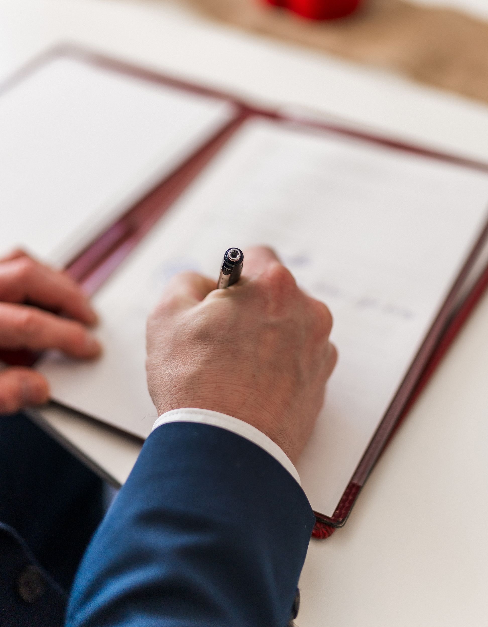 Man signing contract with pen Sydney law firm