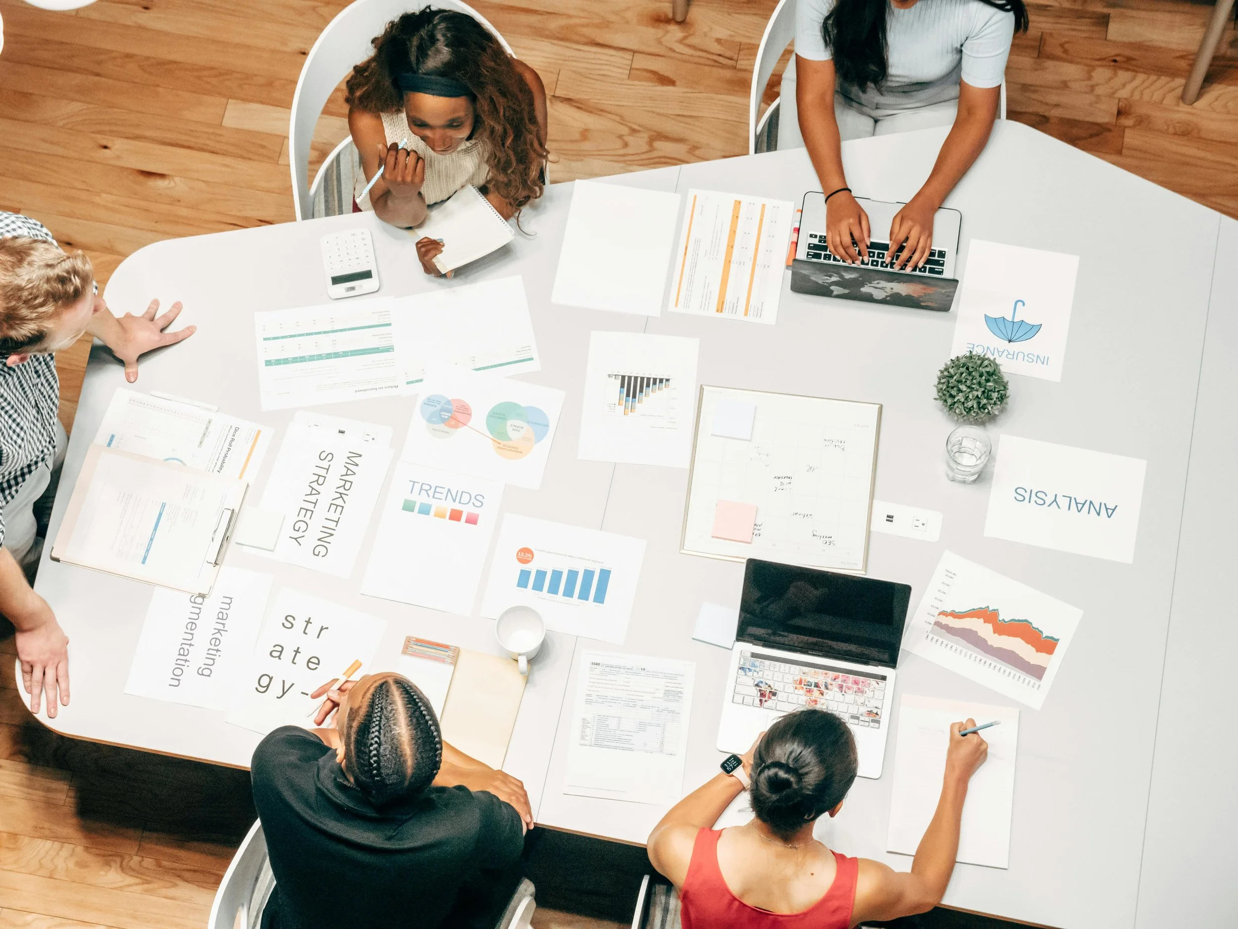 Marketing team reviewing campaign strategy and analytics documents in a meeting