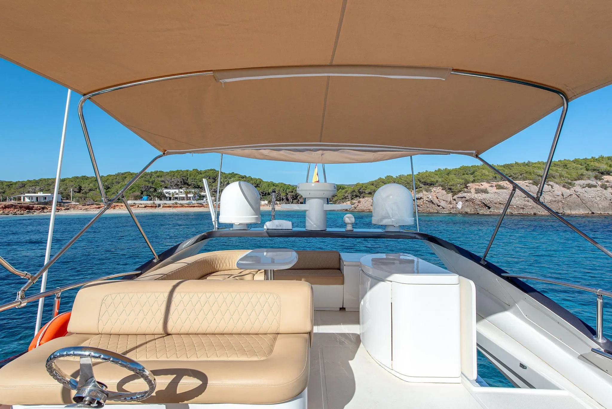 Abacus 61 Estela flybridge seating area with sunshade and coastal views