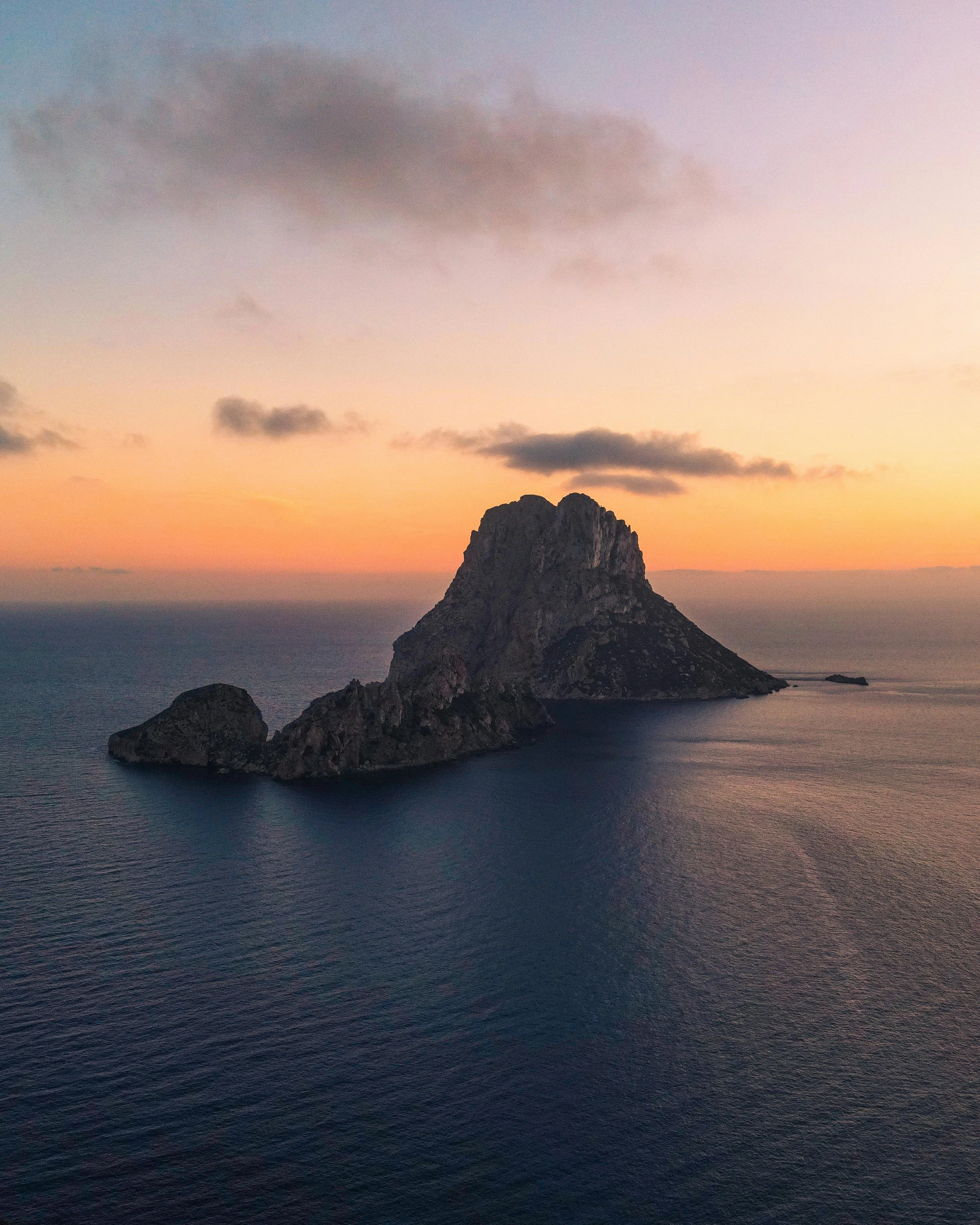 Island at sunset with ocean view and cloudy sky