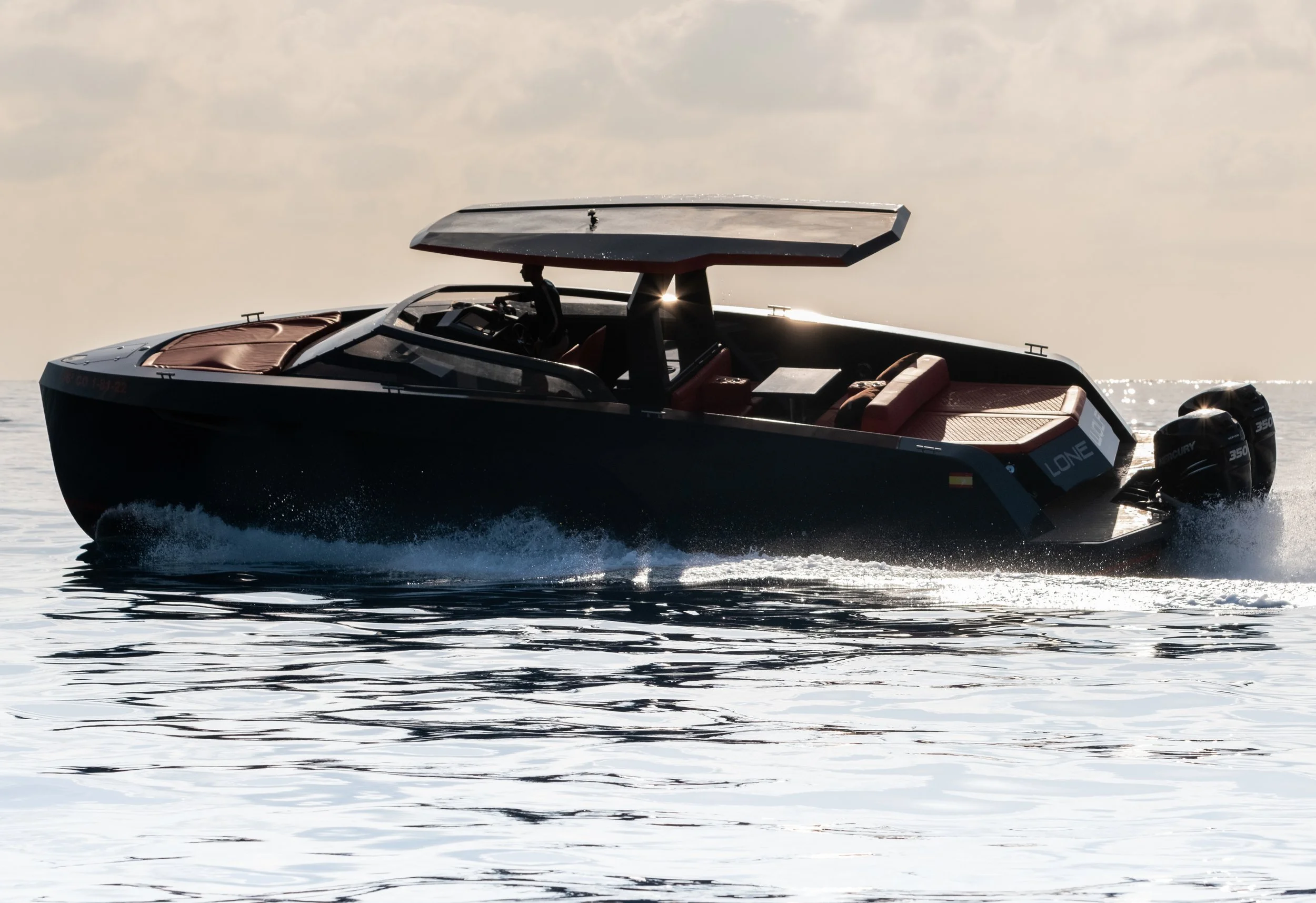 Modern speedboat on water with covered cockpit and outboard motors in sunlight.
