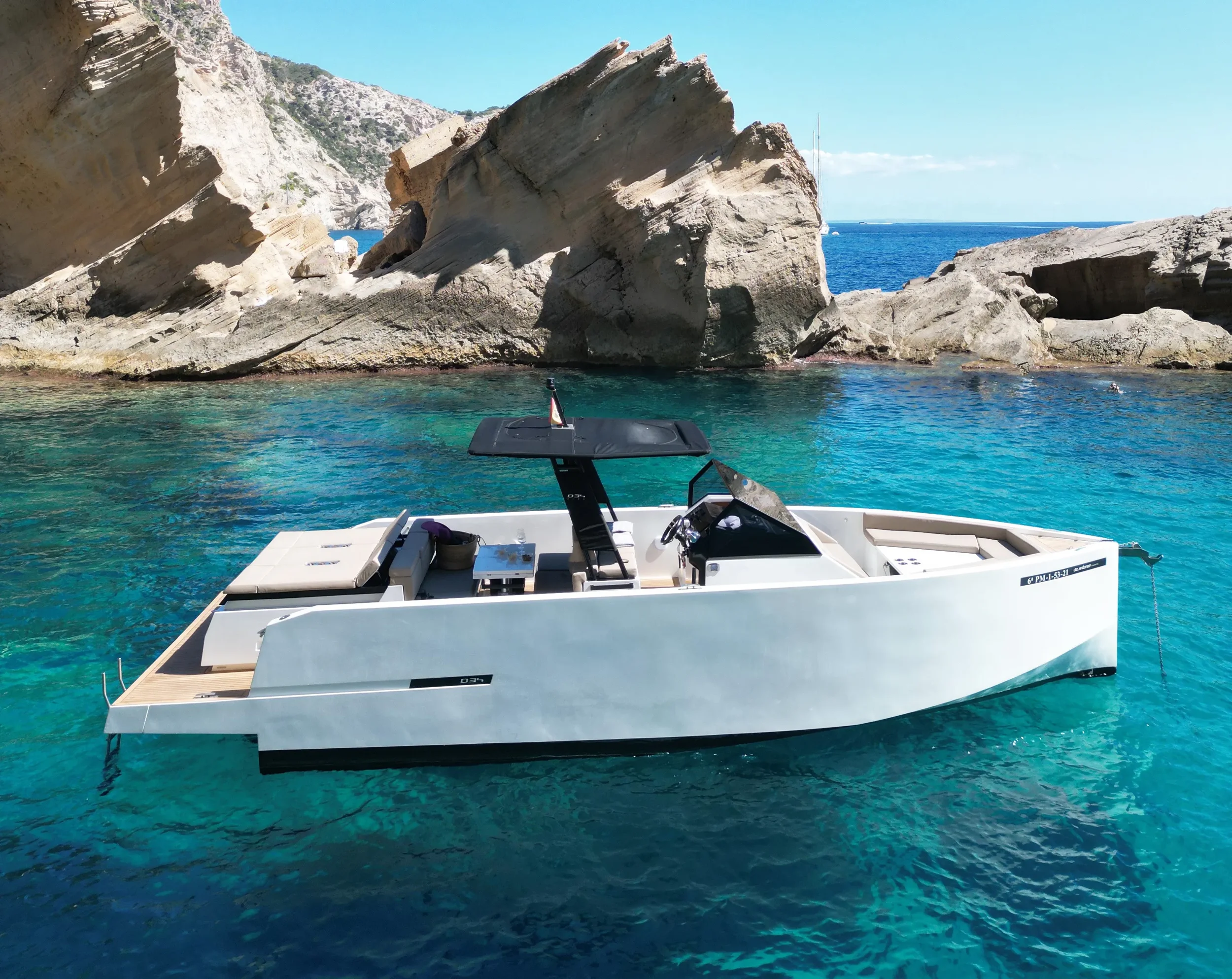 De Antonio 34 Gogga rear angle view cruising near rocky Ibiza coastline