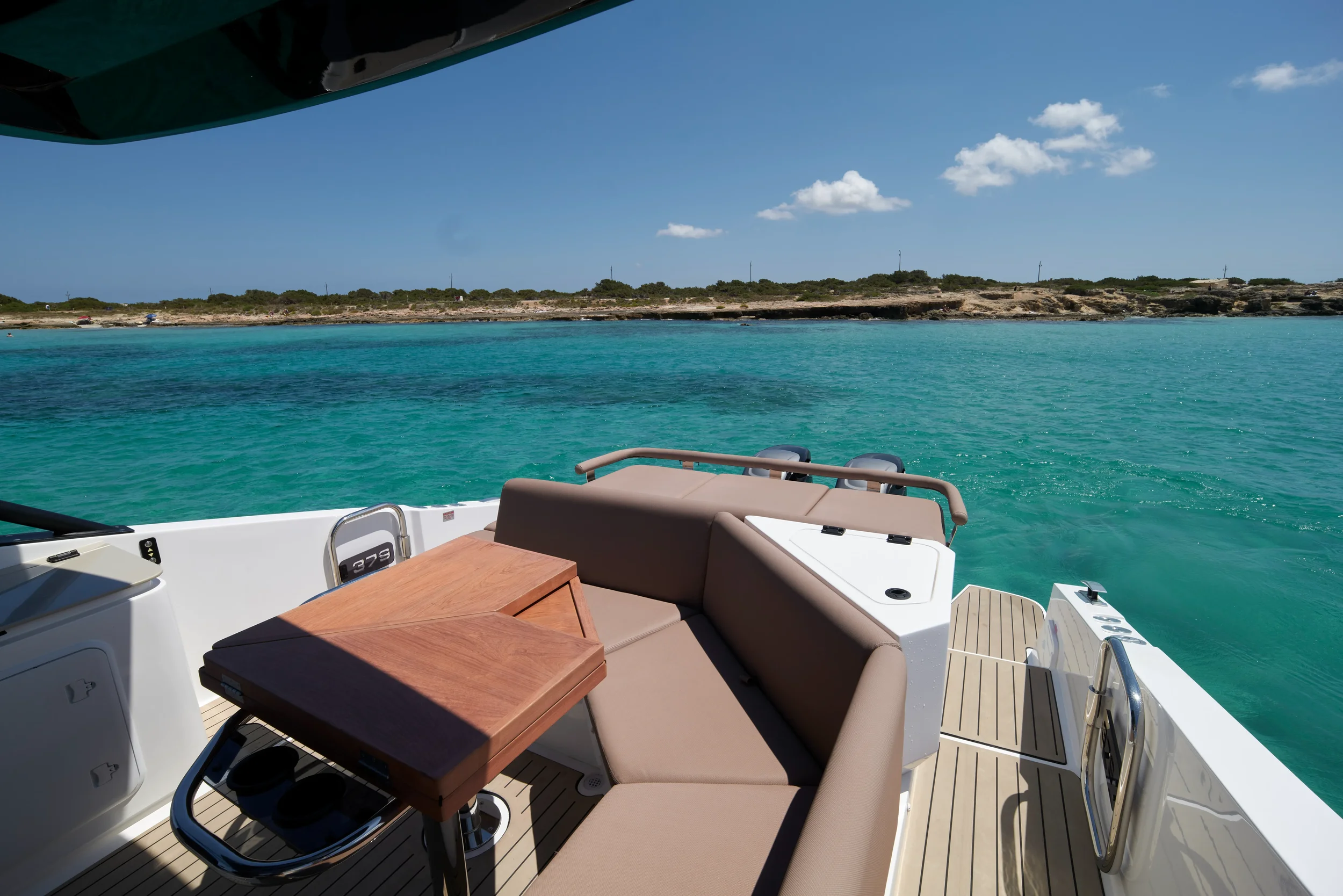 Oryx 38 Santa Cruz bow sunbed area with sea views under clear Ibiza sky