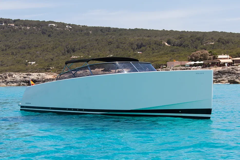 VanDutch 40 side profile at anchor near Ibiza coastline with smooth hull lines