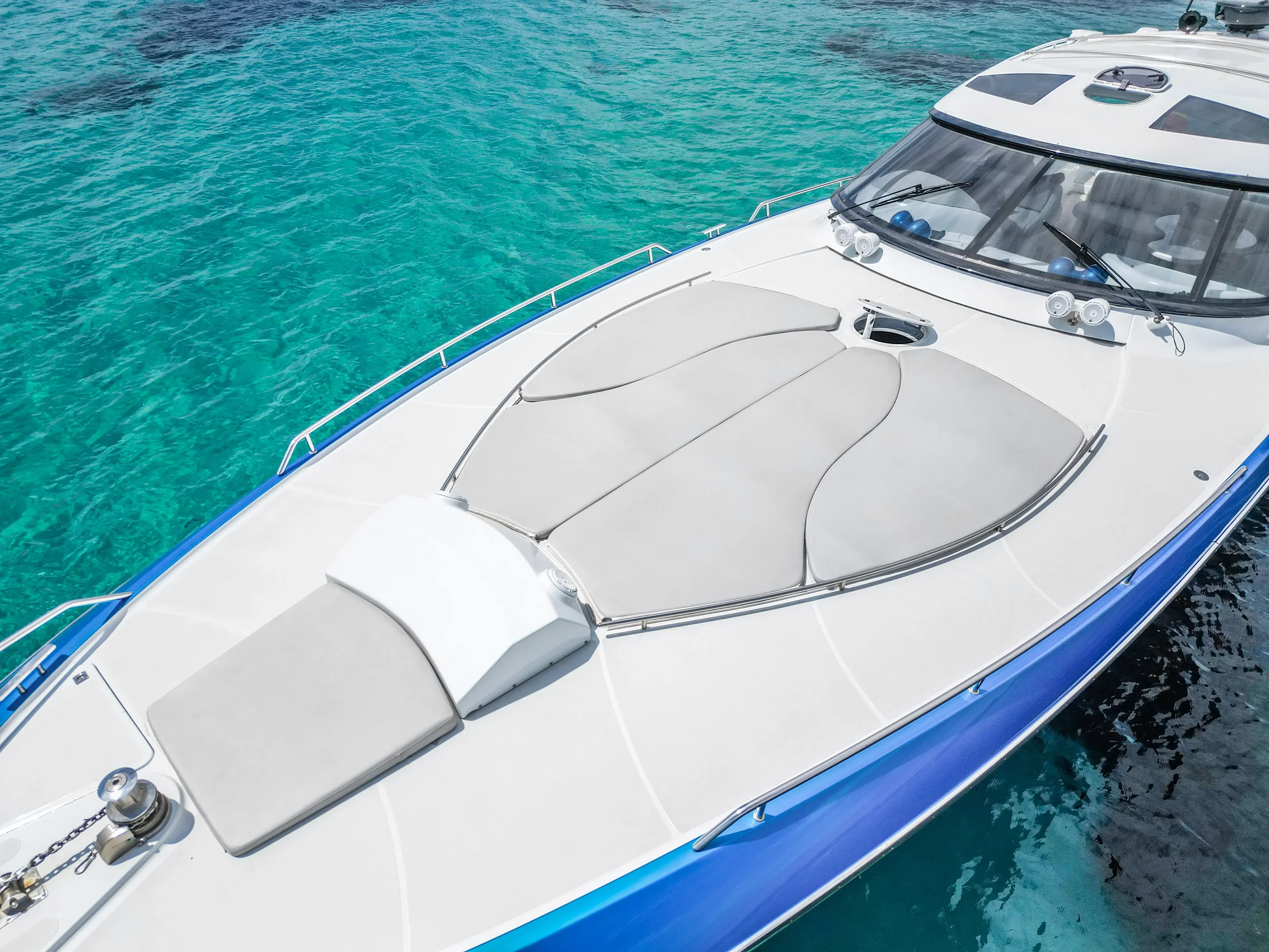 Baia 54 Surreal bow sunbed area shown from above while anchored in calm water.