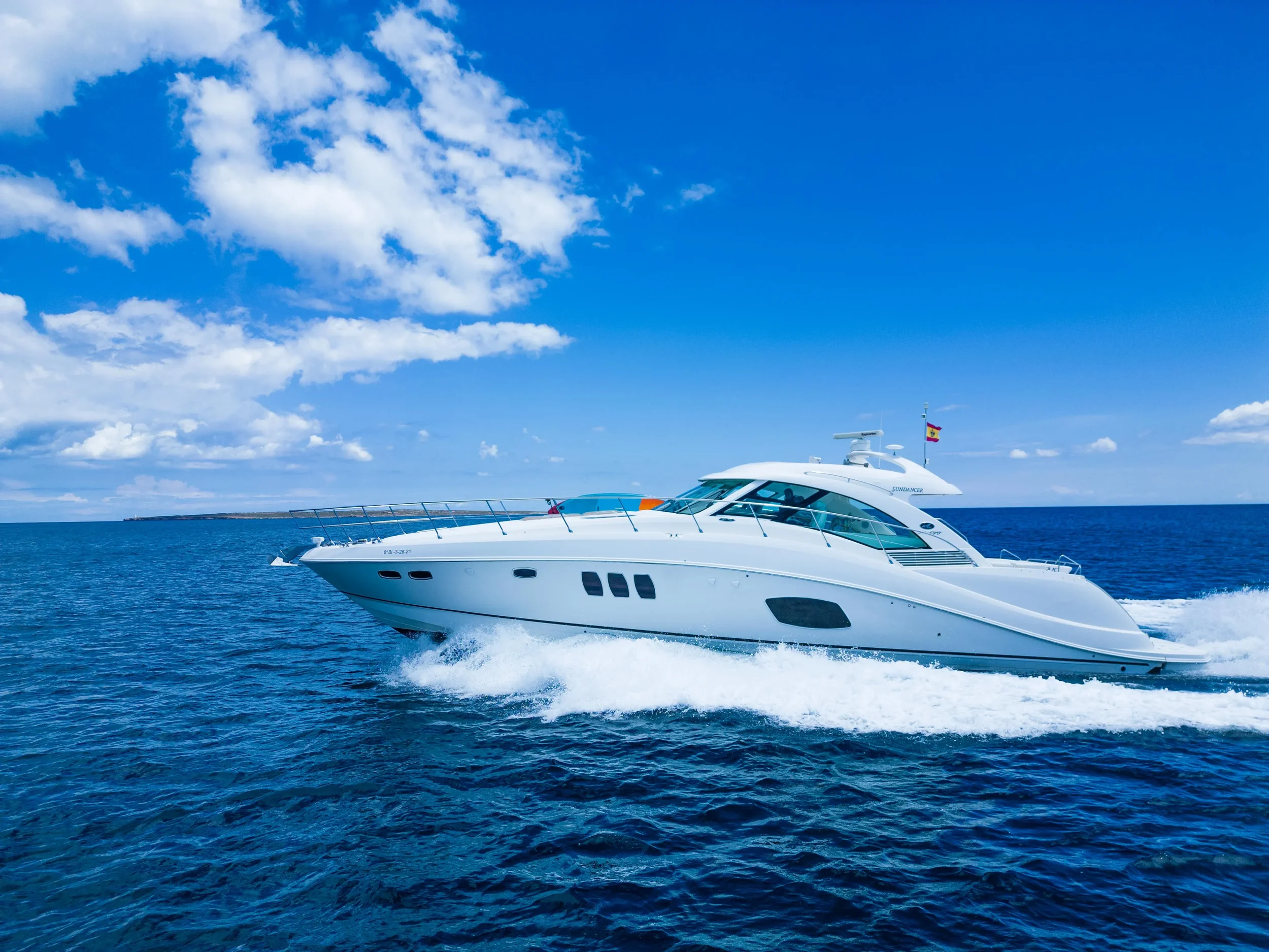 Sea Ray 55 Il Consigliere cruising across clear Ibiza waters on a sunny day