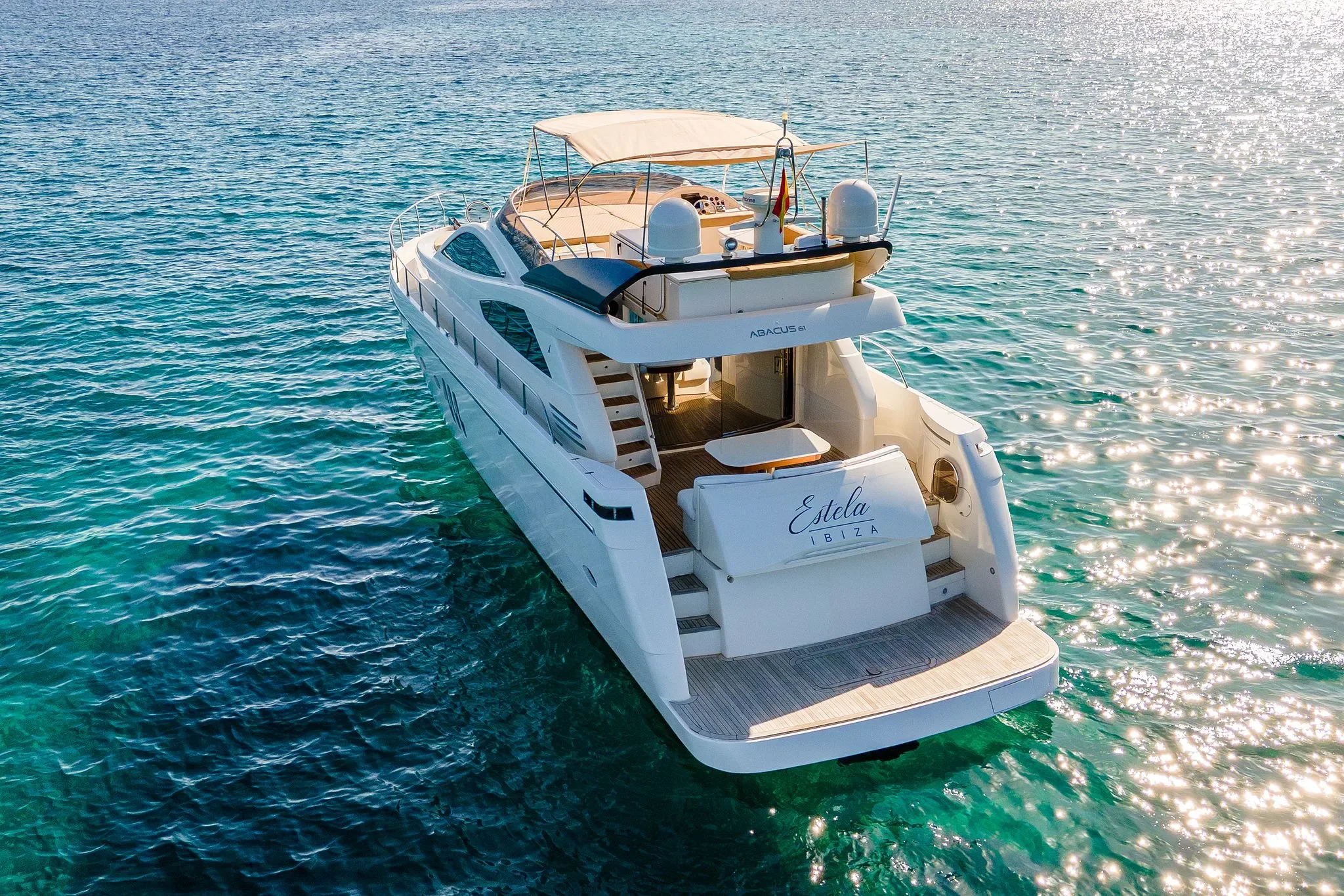 Abacus 61 Estela stern angle with swim platform and flybridge overlooking Ibiza waters