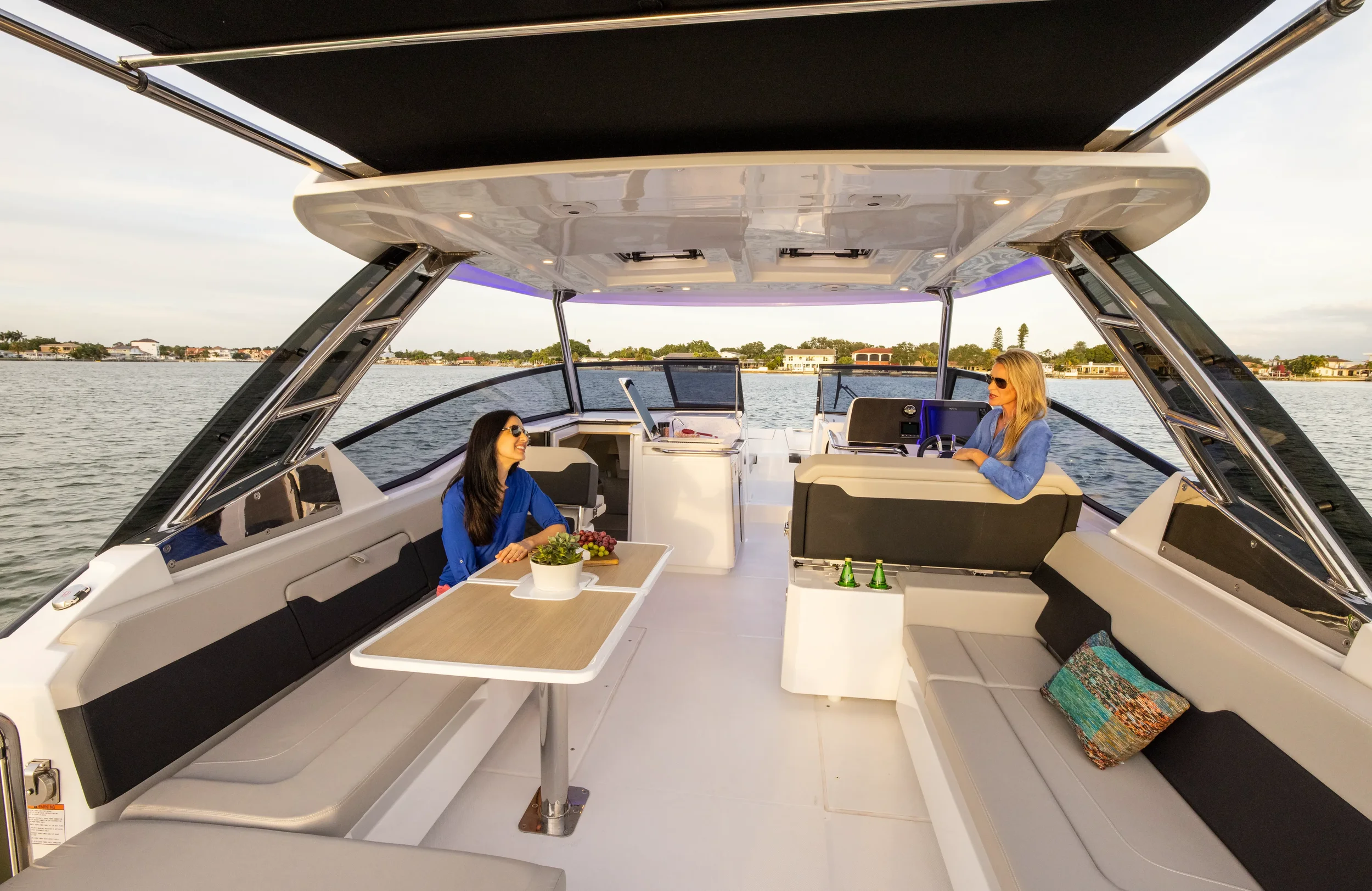 aquila 32 sport interior lounge area with central table and seating designed for social cruising