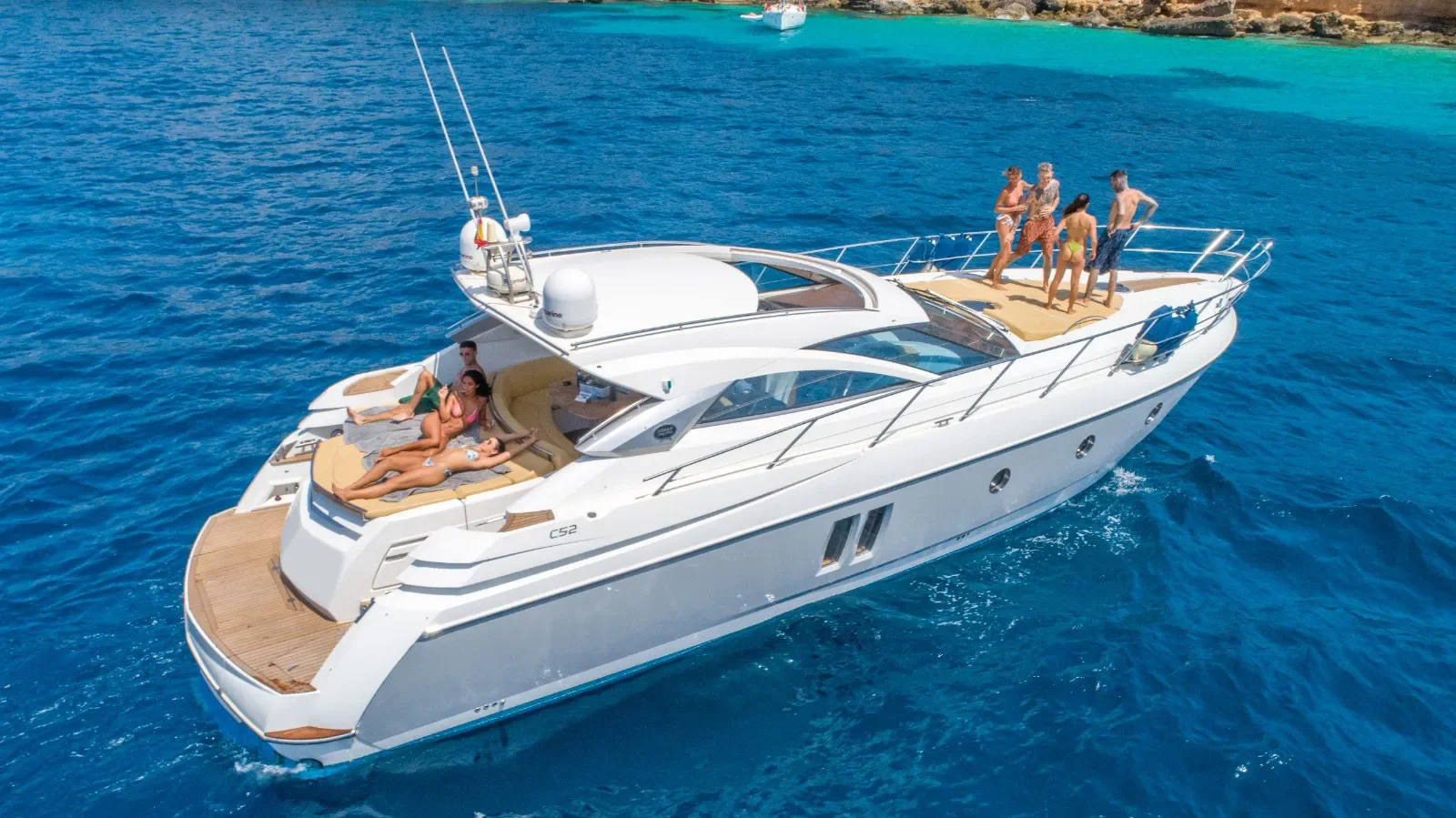 Sessa Marine 52 rear deck and flybridge view with guests enjoying the open layout at sea