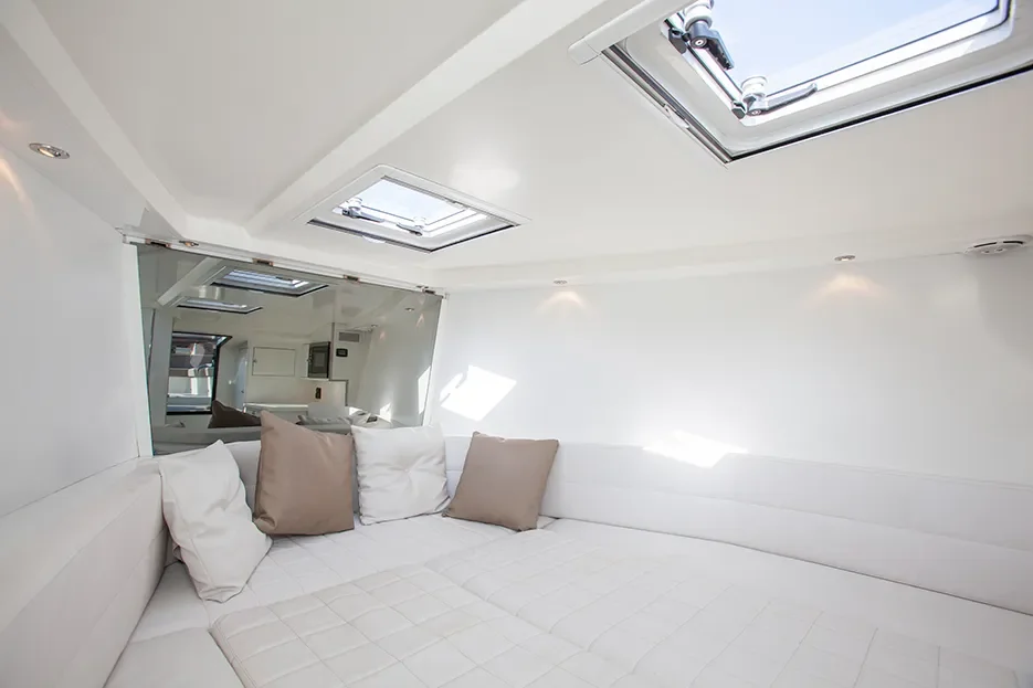VanDutch 40 interior cabin with bright white finish and natural light from overhead windows