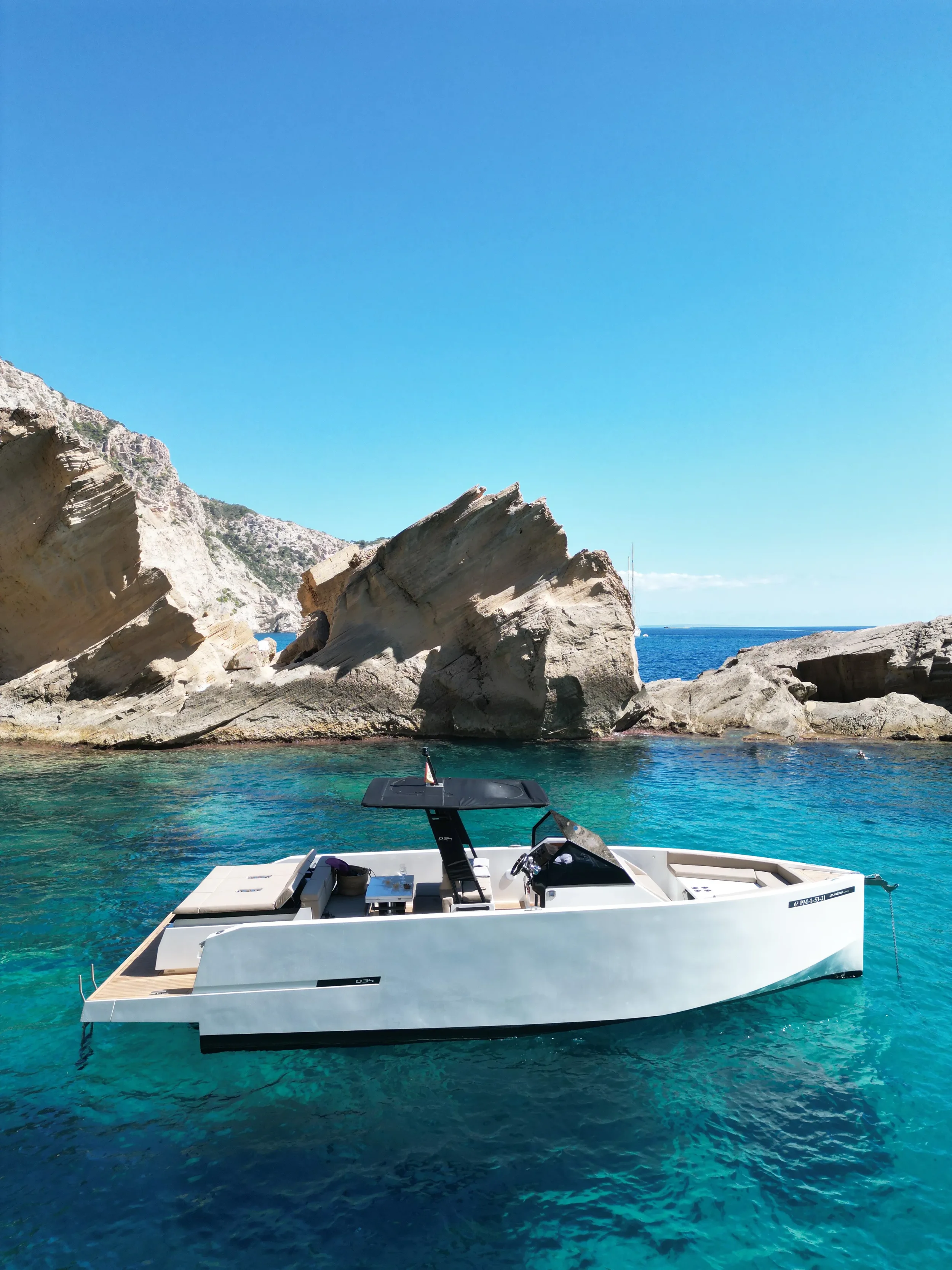 De Antonio 34 Gogga side profile anchored in clear turquoise water Ibiza