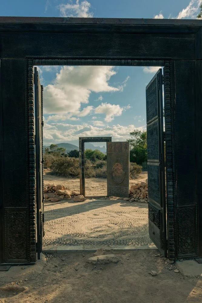 Ancient gate in outdoor setting with stone pathway and open sky