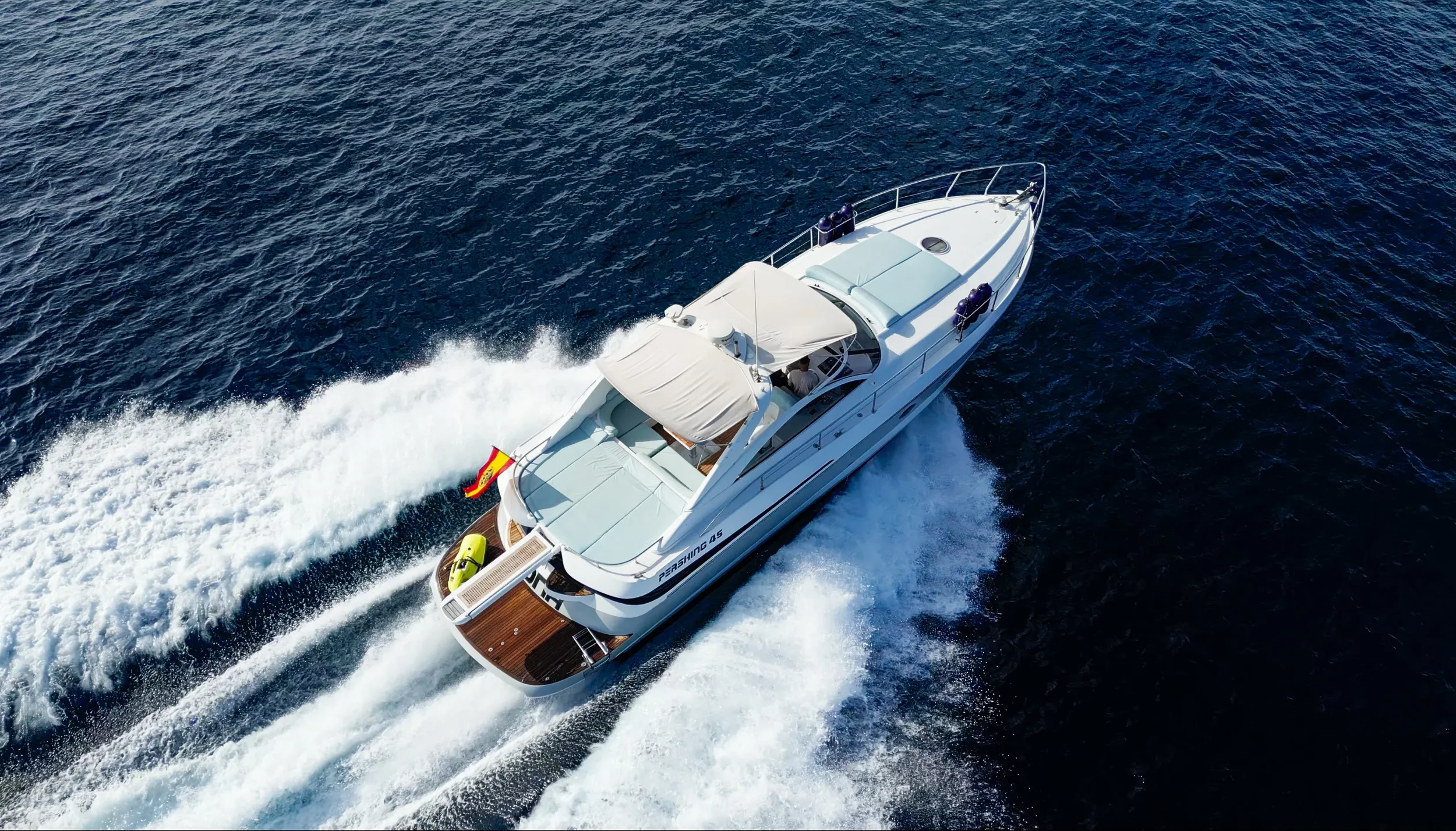 Pershing 45 Nona viewed from above cruising at speed over deep blue water near Ibiza