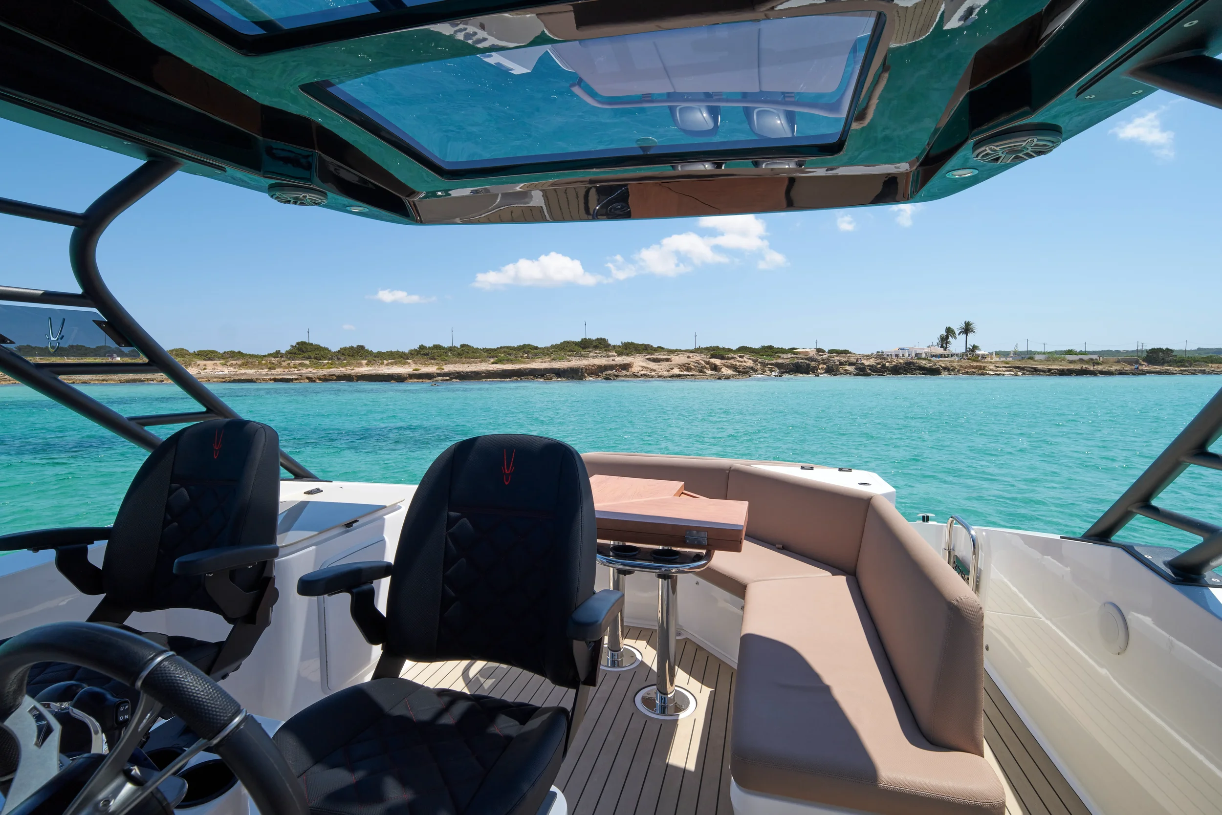 Oryx 38 Santa Cruz cockpit seating area overlooking turquoise water
