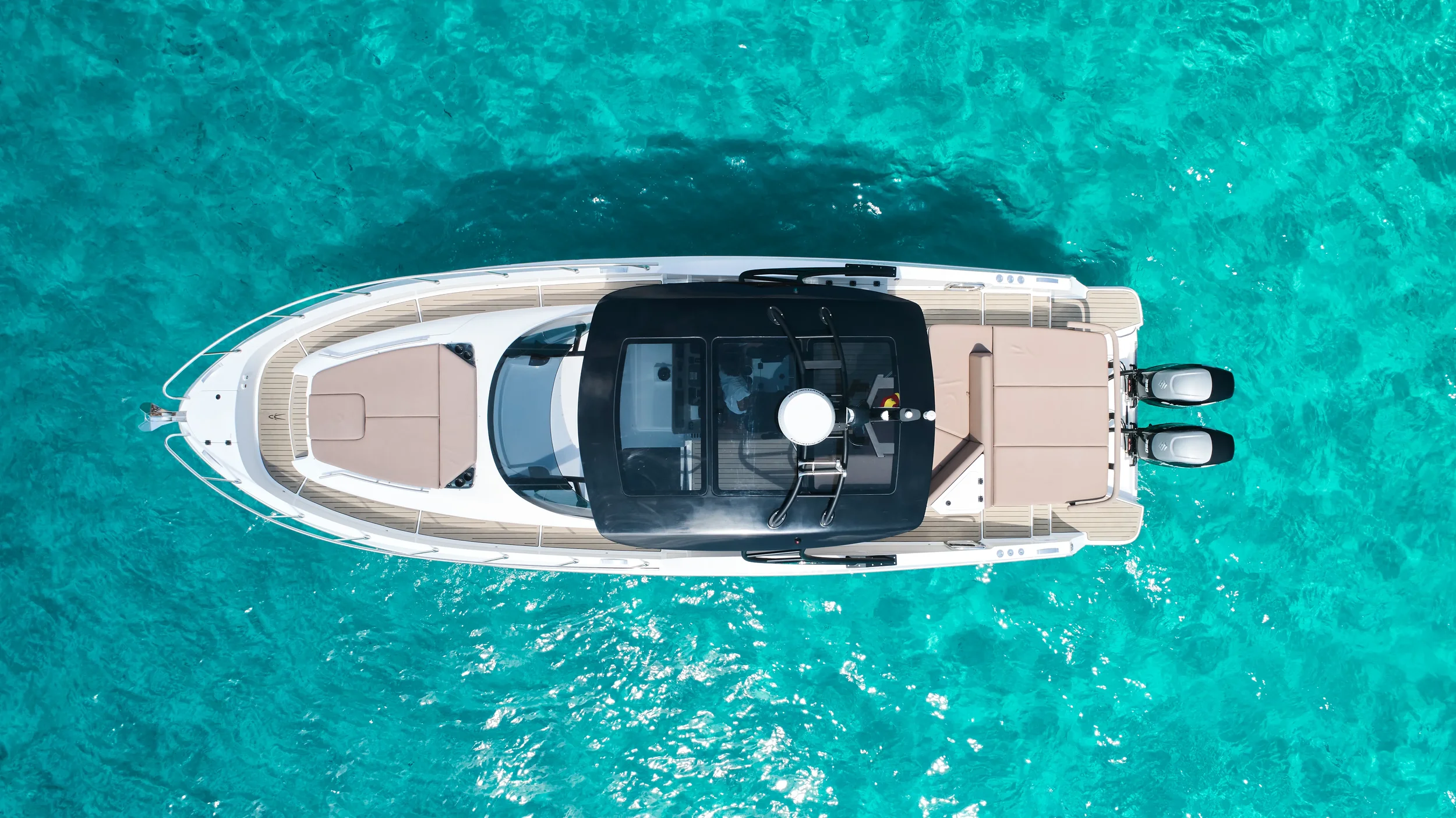 Oryx 38 Santa Cruz viewed from above showing open deck layout on turquoise water