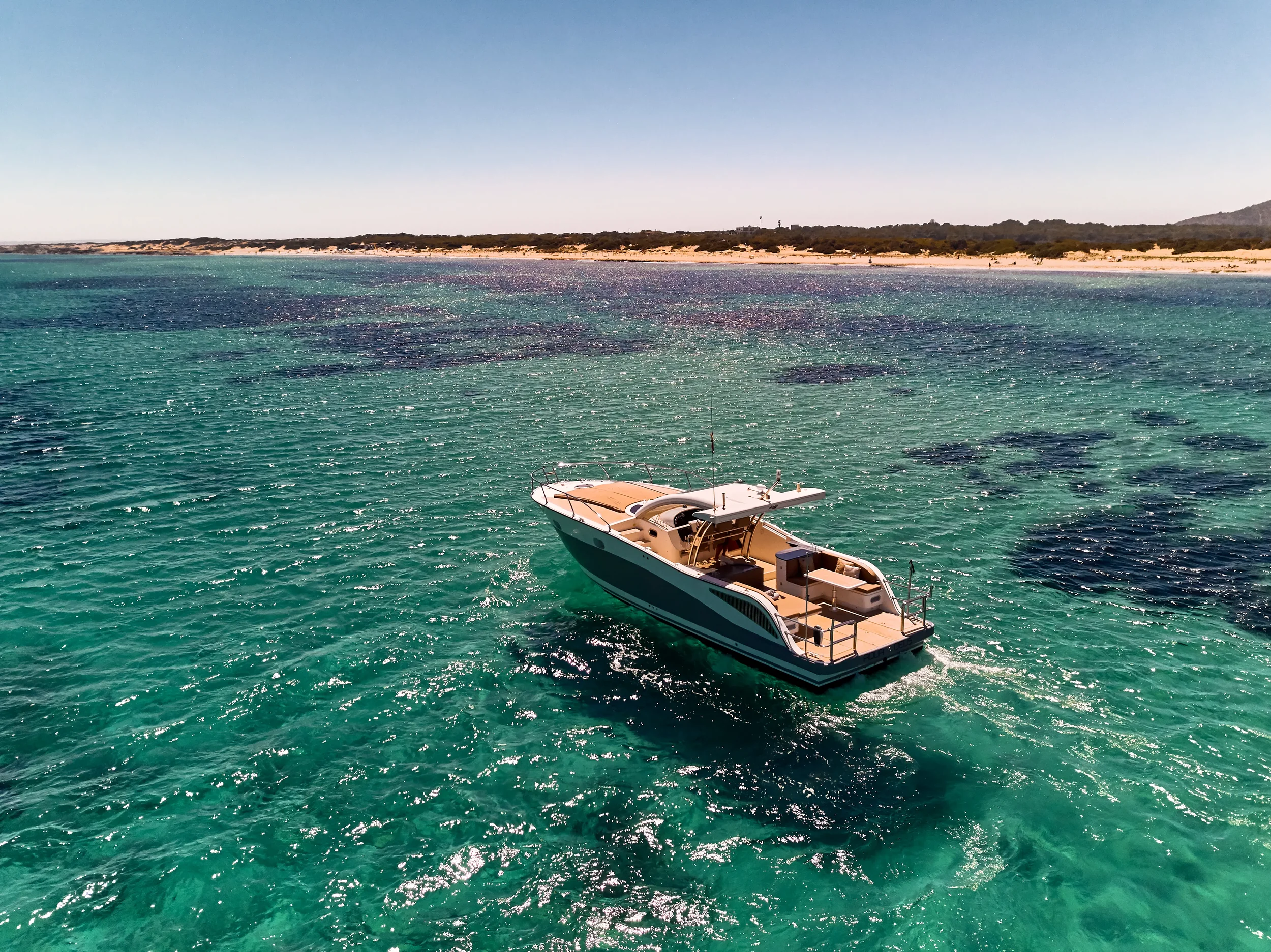 Astromar Xsea 42 viewed from above drifting peacefully in shallow Mediterranean water