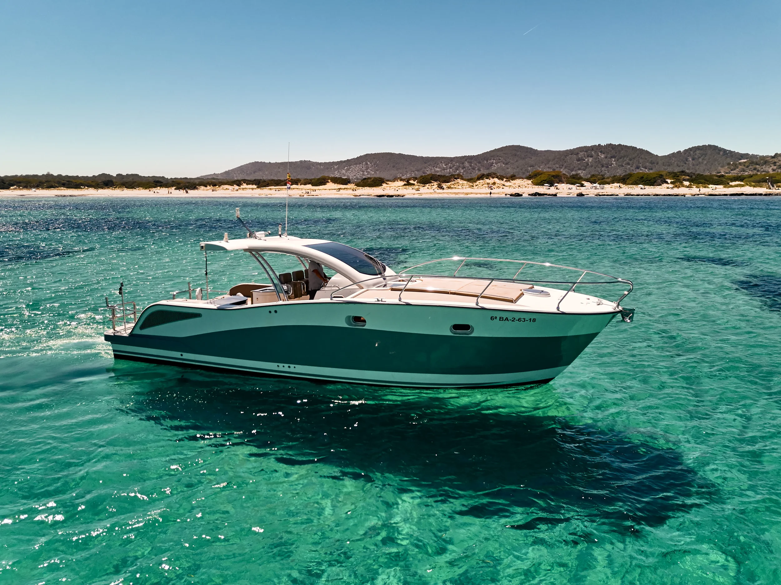 Astromar Xsea 42 cruising calmly over clear turquoise water near the Ibiza coastline