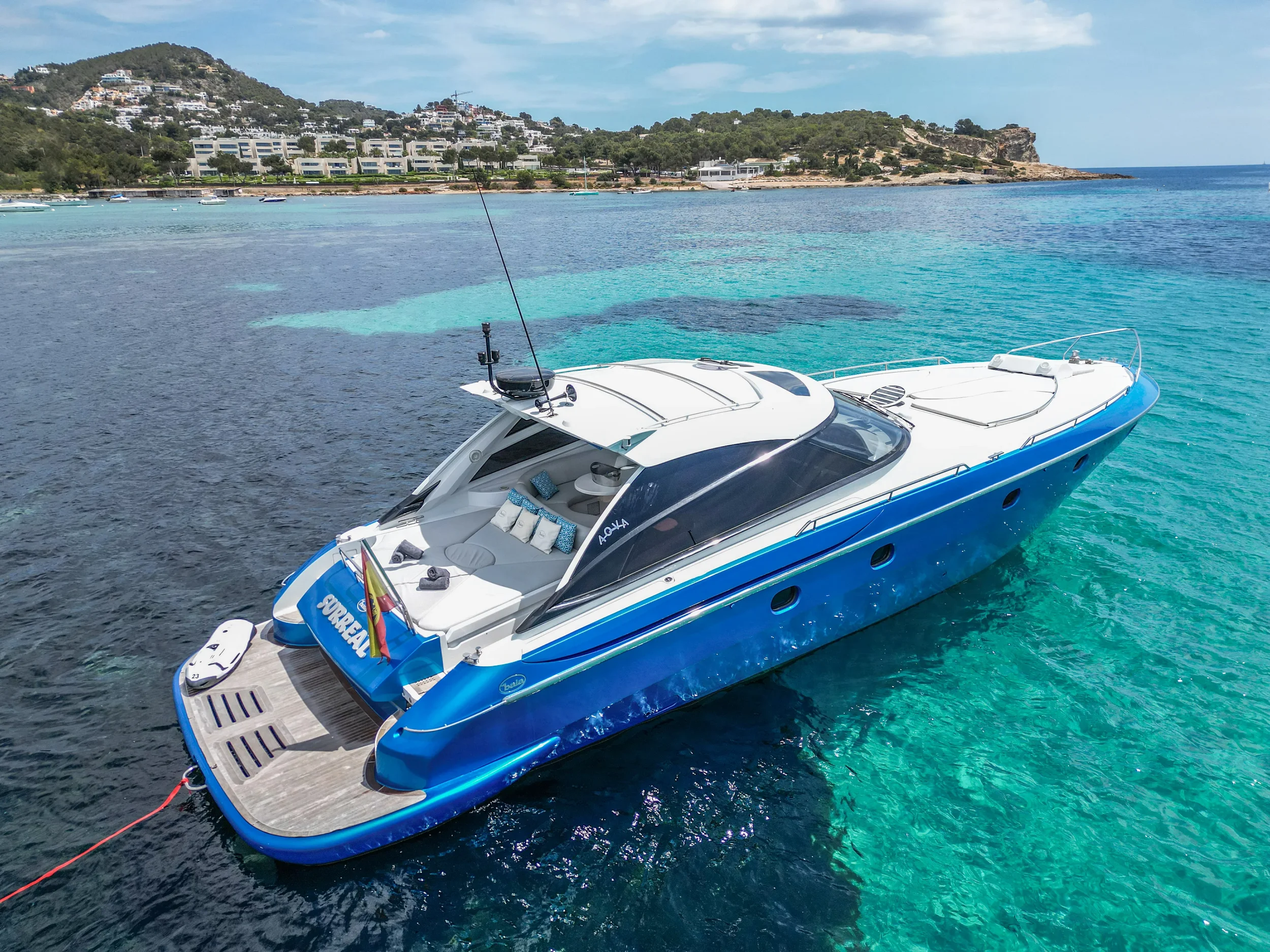 Baia 54 Surreal cruising slowly over turquoise water near the Ibiza coastline.