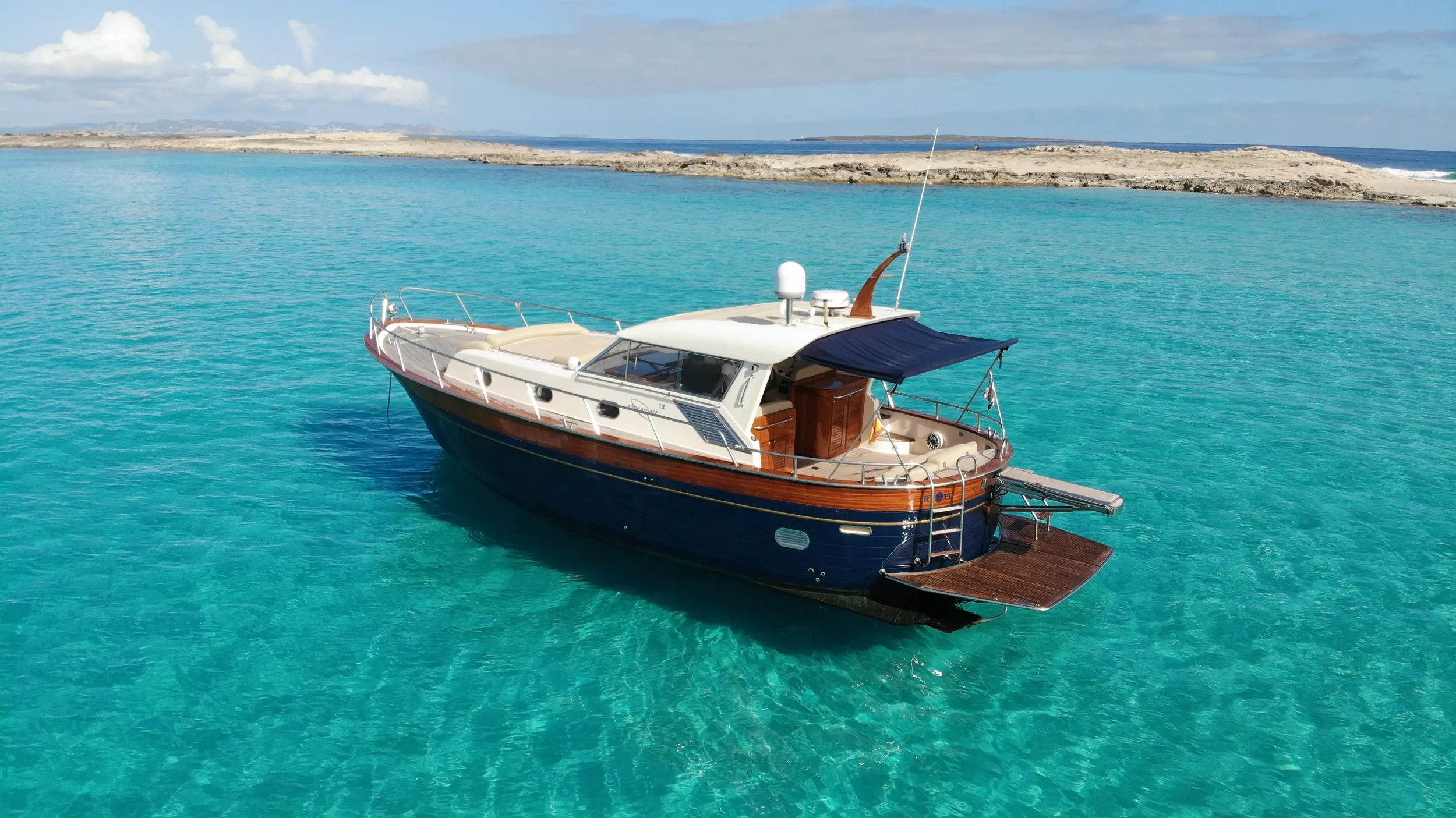 apreamare 45 scamp floating gently in calm turquoise water with the stern terrace open toward the sea.