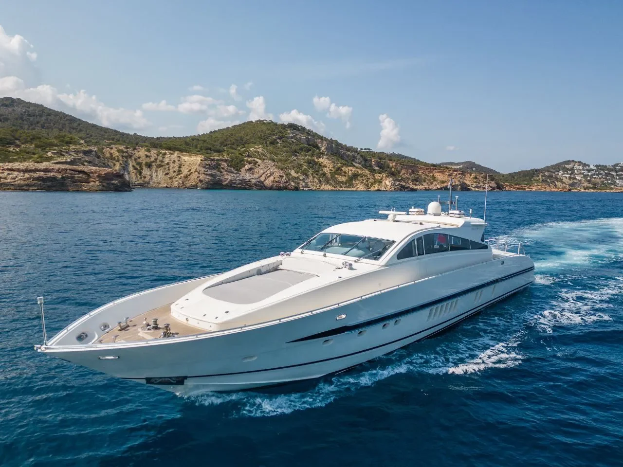 Leopard 27 Byron cruising smoothly along the ibiza coastline in calm blue water