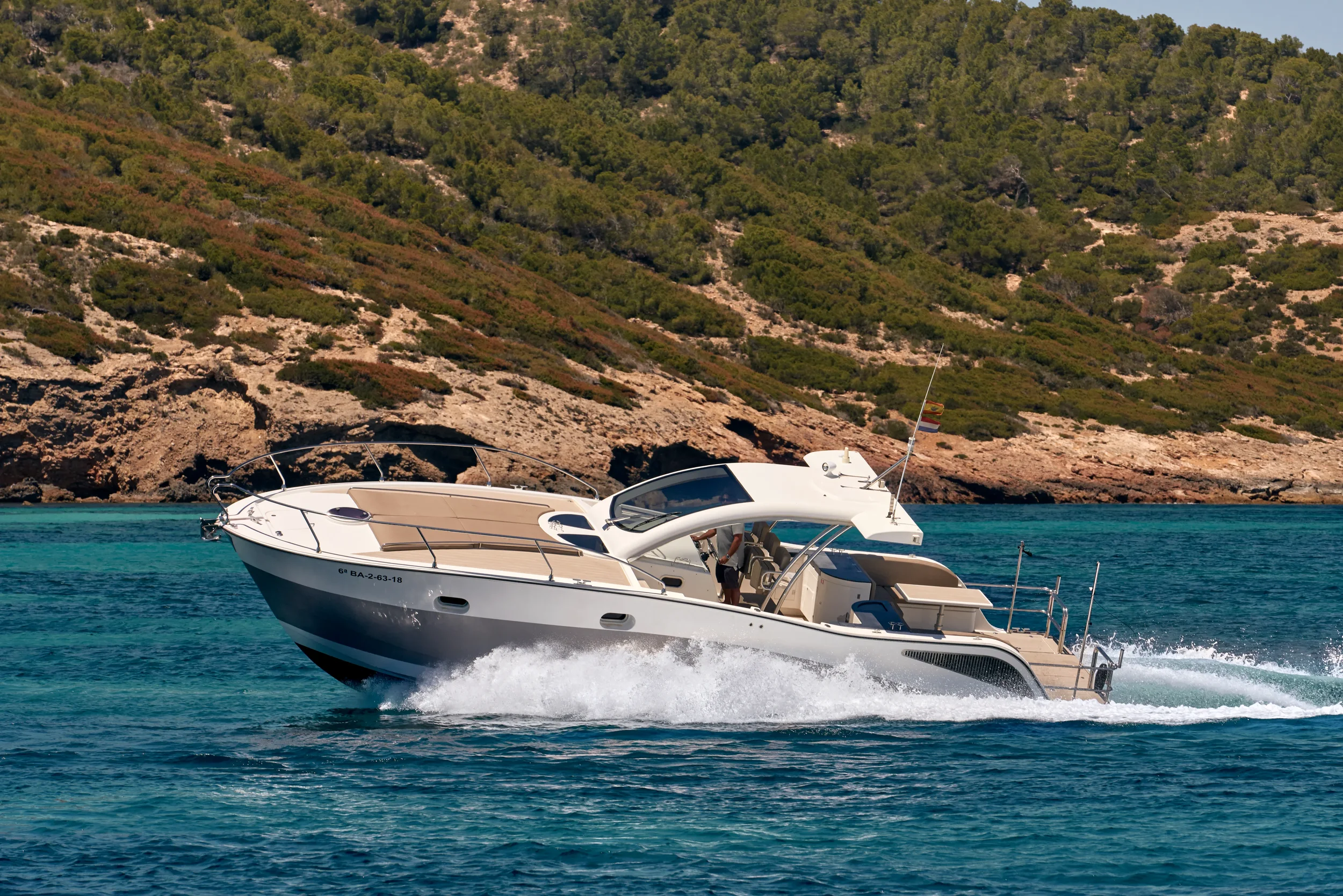 Astromar Xsea 42 side profile underway with coastline in the background