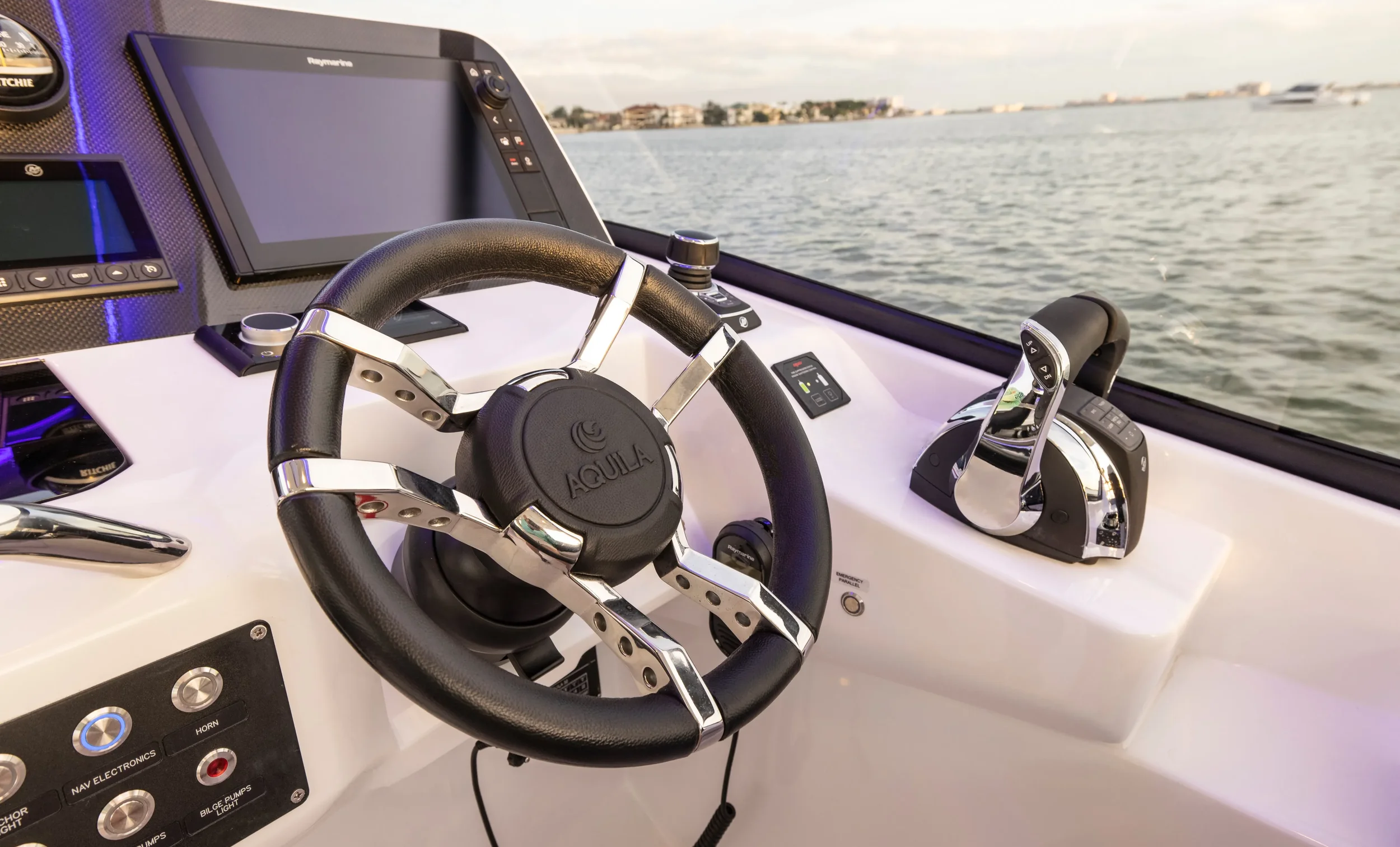 aquila 32 sport helm station with modern steering controls and clear forward visibility