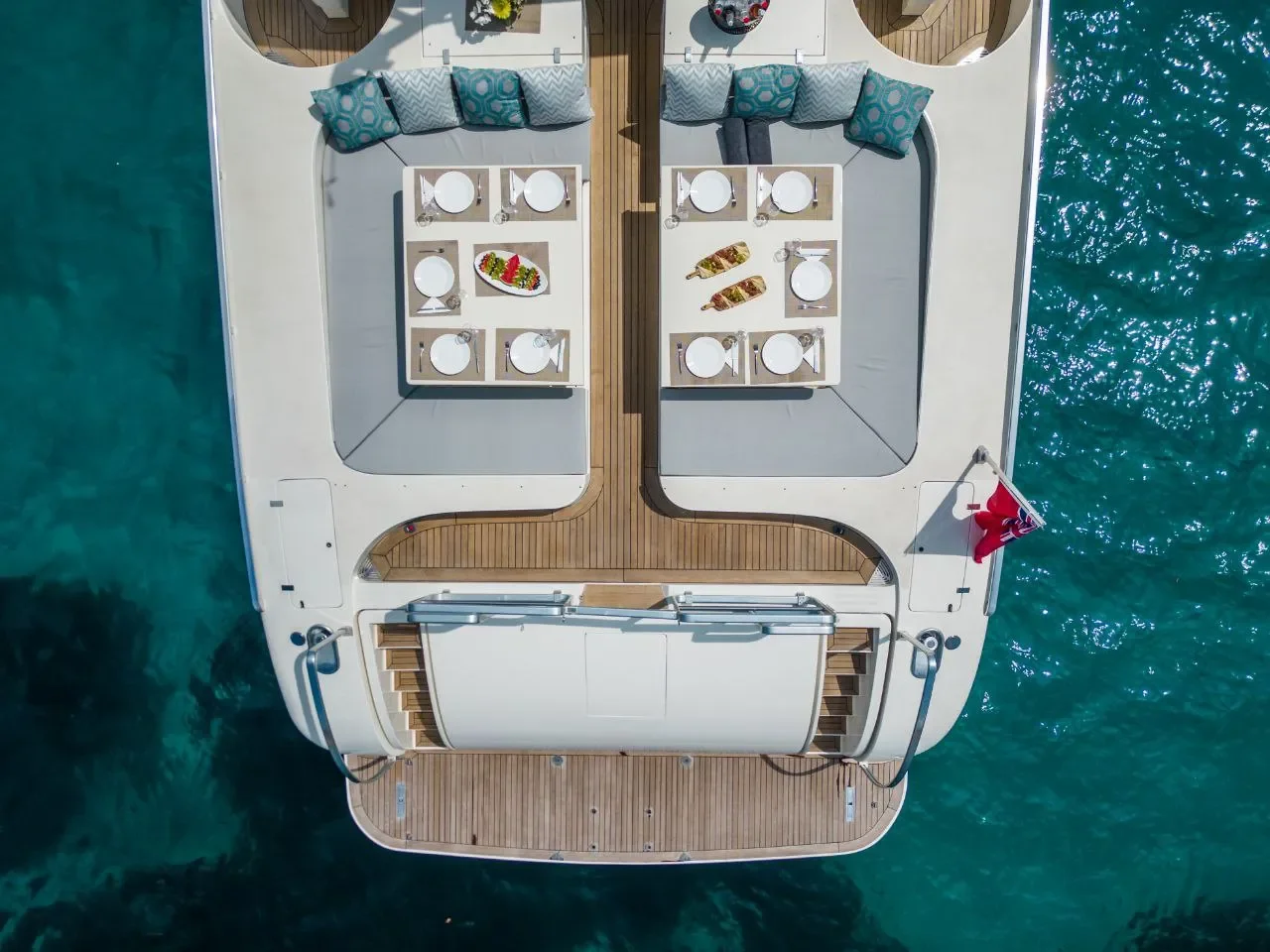 Leopard 27 Byron top view of aft deck and sunbed area over clear water