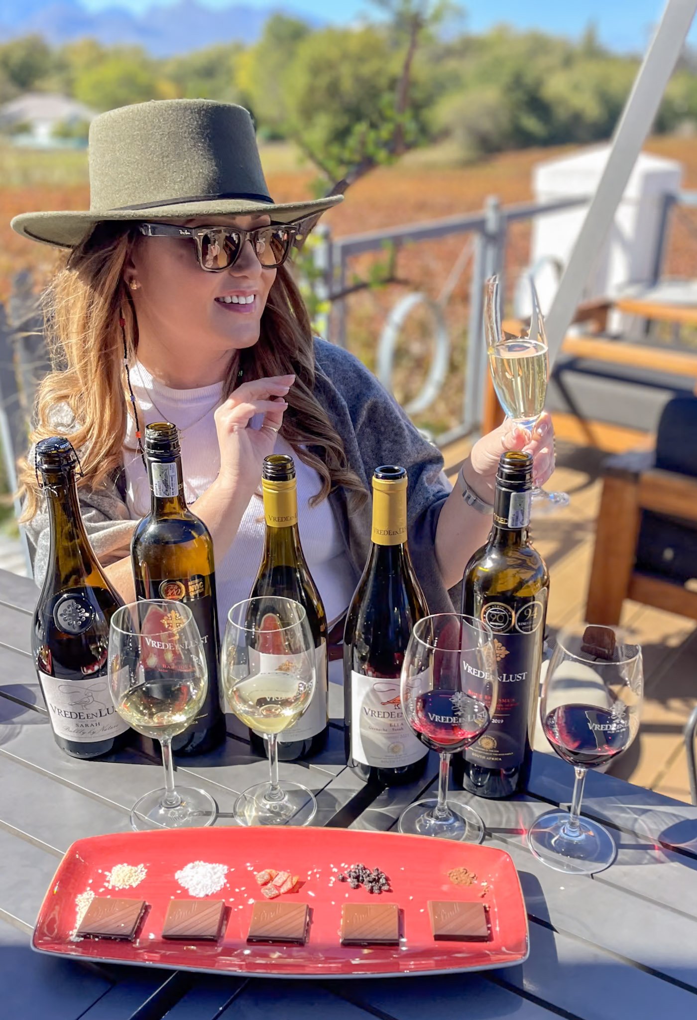 The Wine Girl tasting through five glasses of wine paired with chocolate in the Franschhoek Wine Region of South Africa