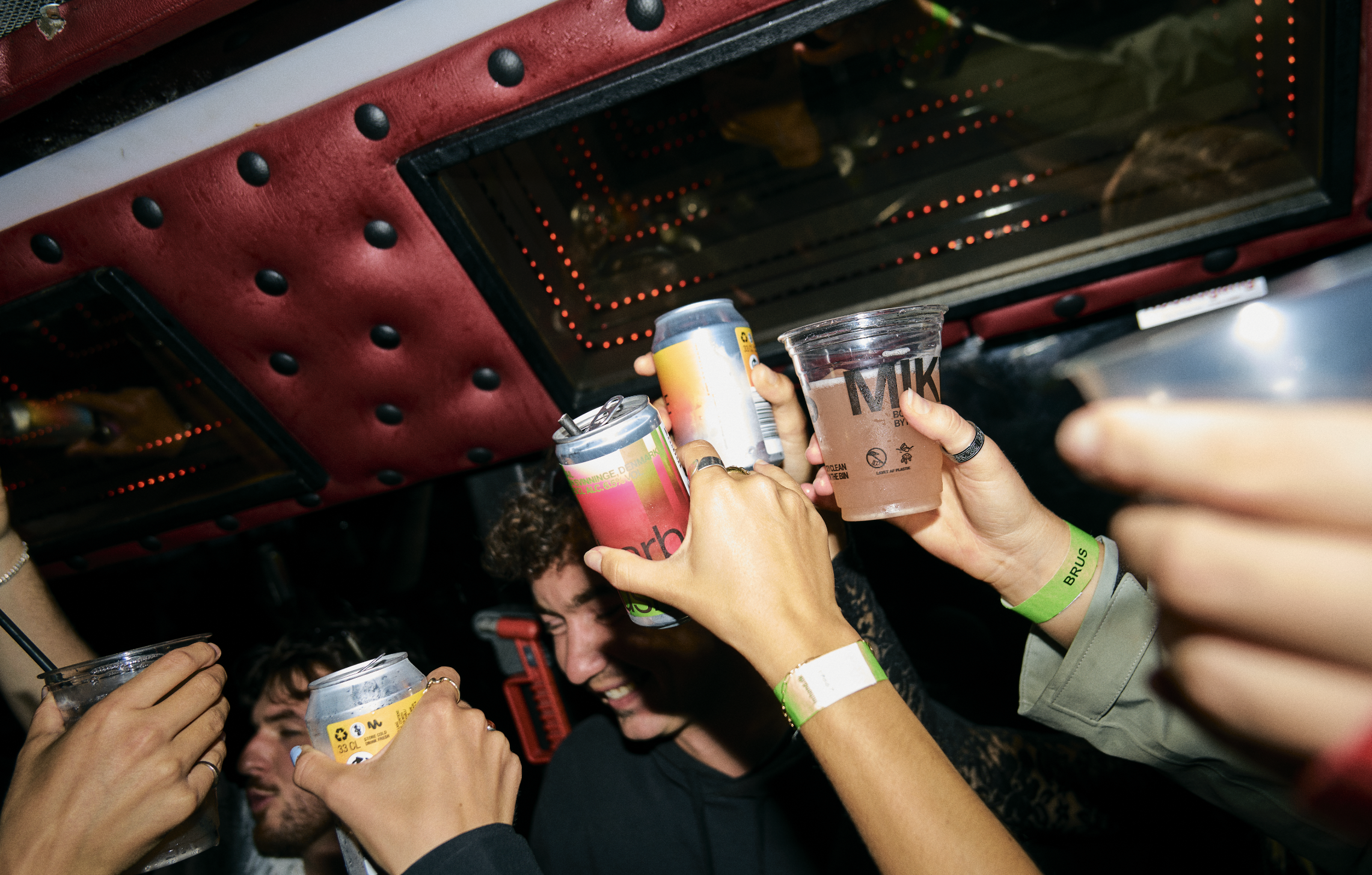 Group of friends raising drinks and toasting at a party or celebration.