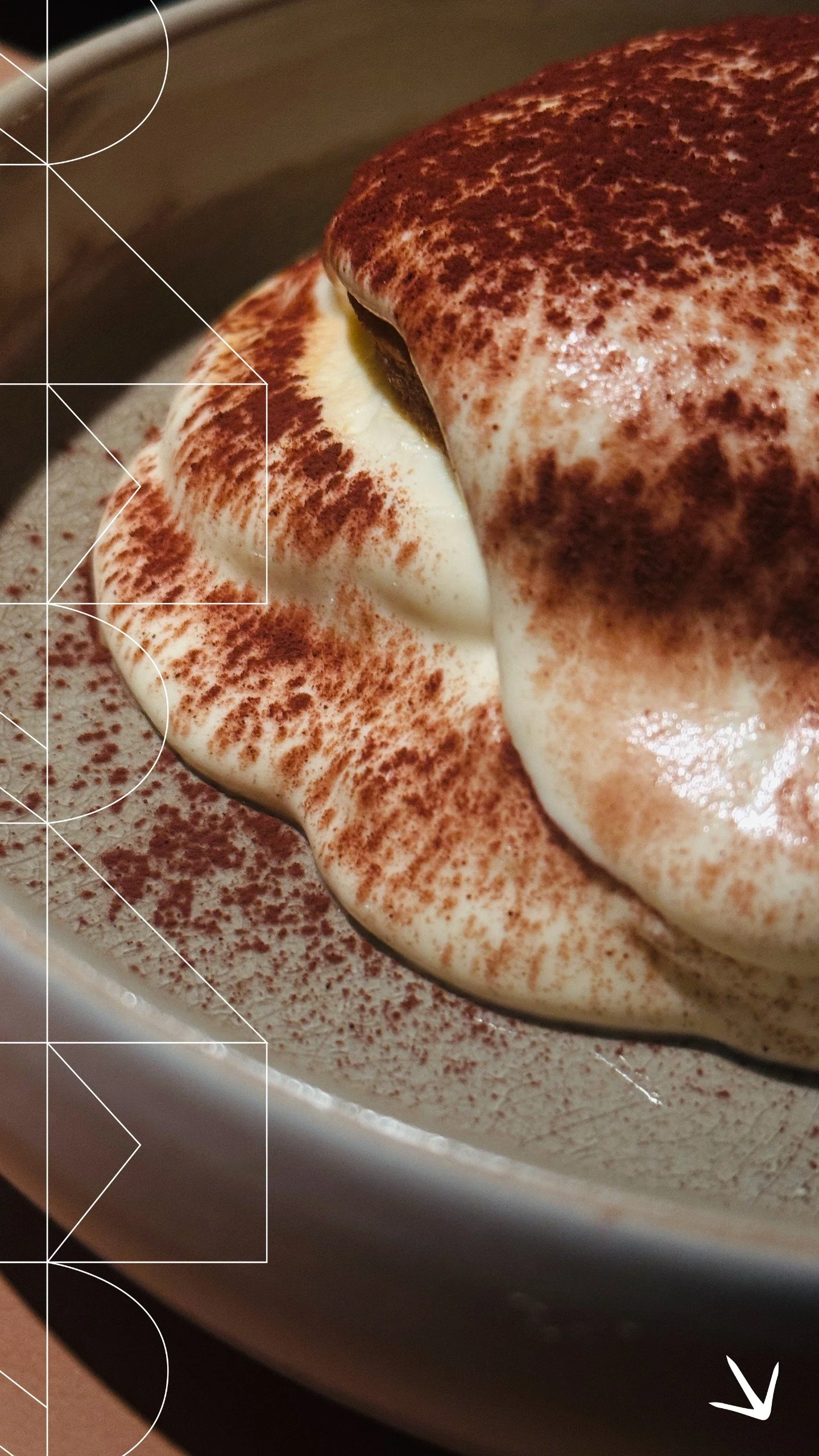 Naama specialty Tiramisù, with creamy layers topped with cocoa powder in a bowl.
