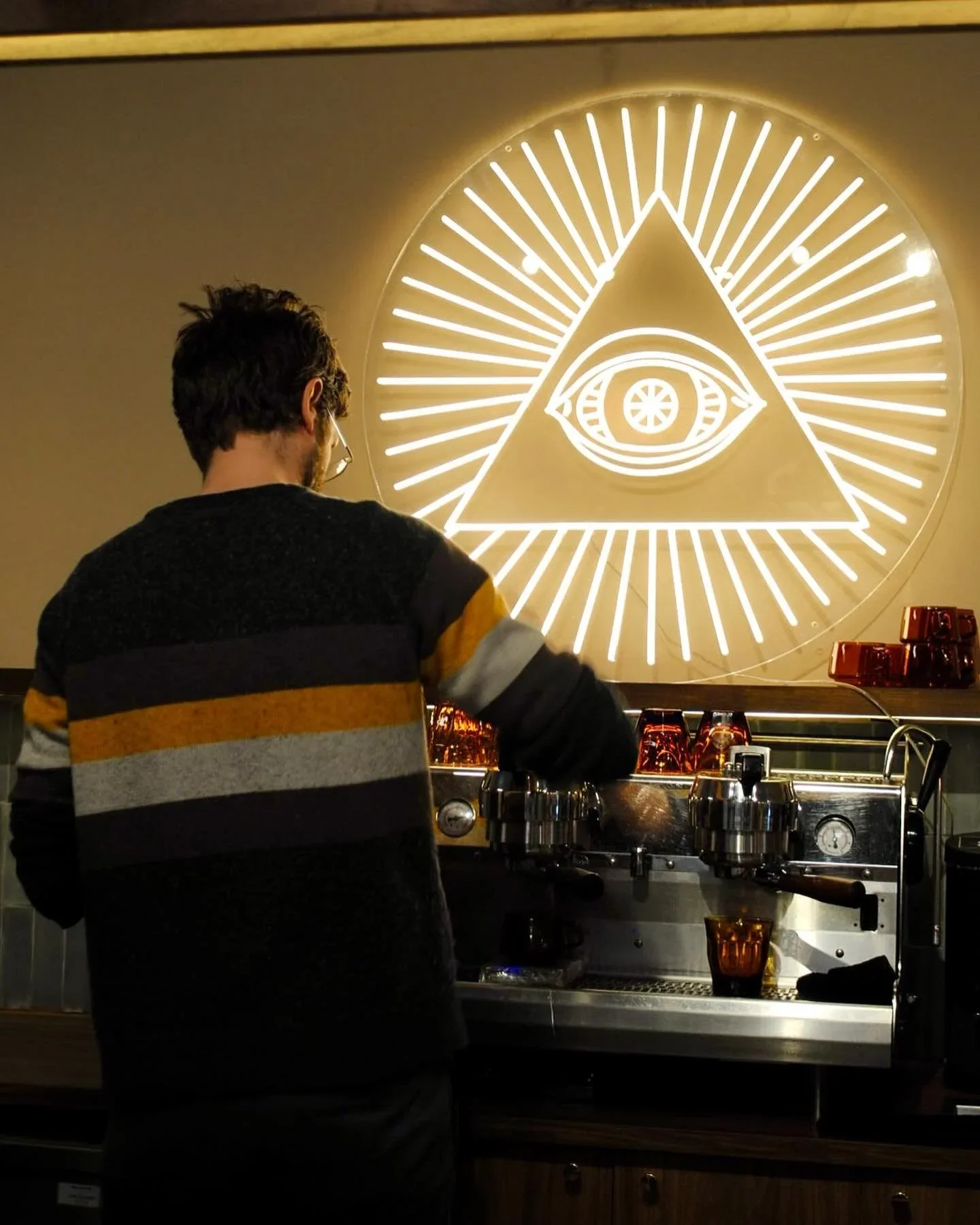 A photo of an employee making coffee at one of the Ministry of Coffee locations.