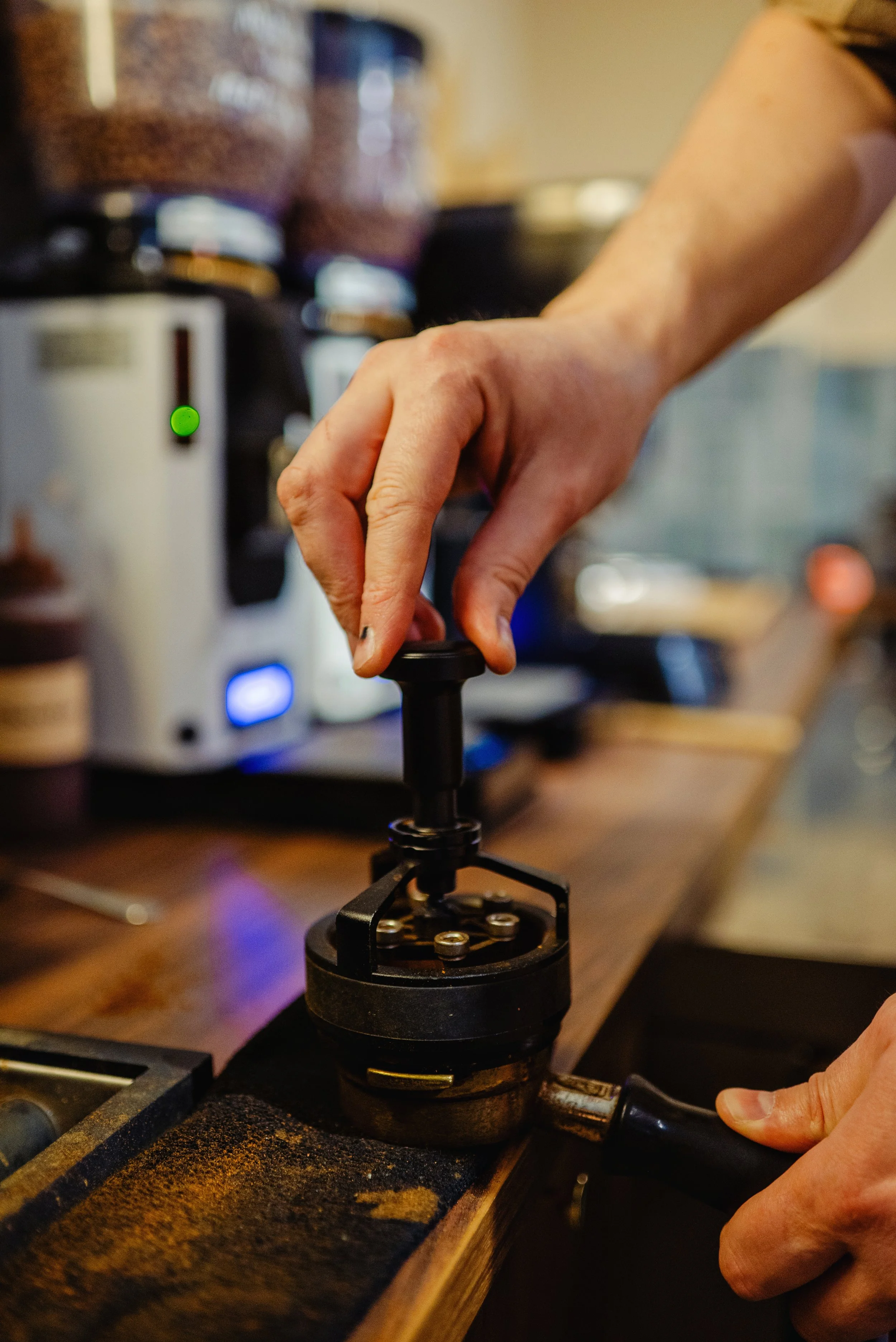 Photo of coffee beans being pressed.