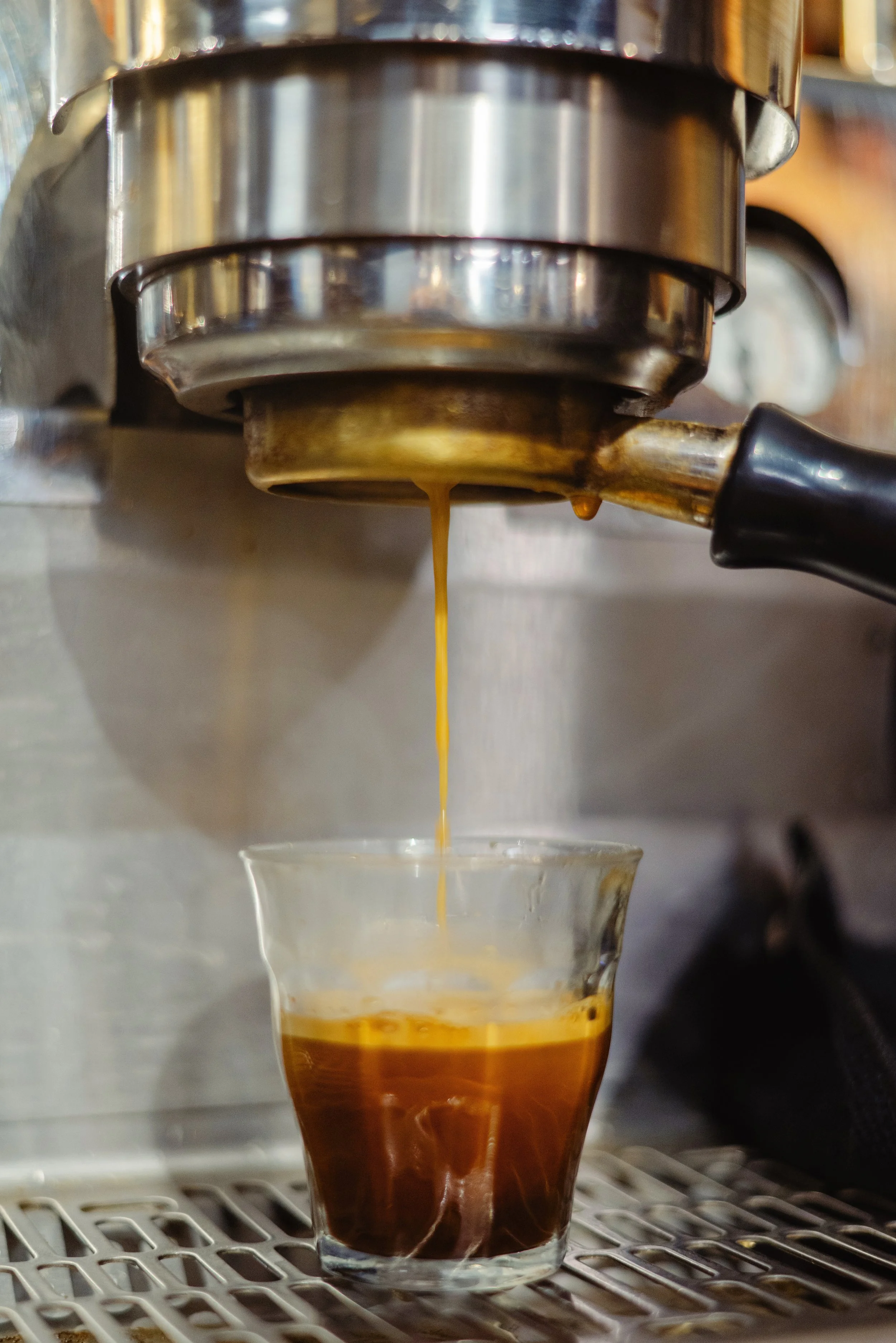 A photo of espresso being made from a coffee machine.