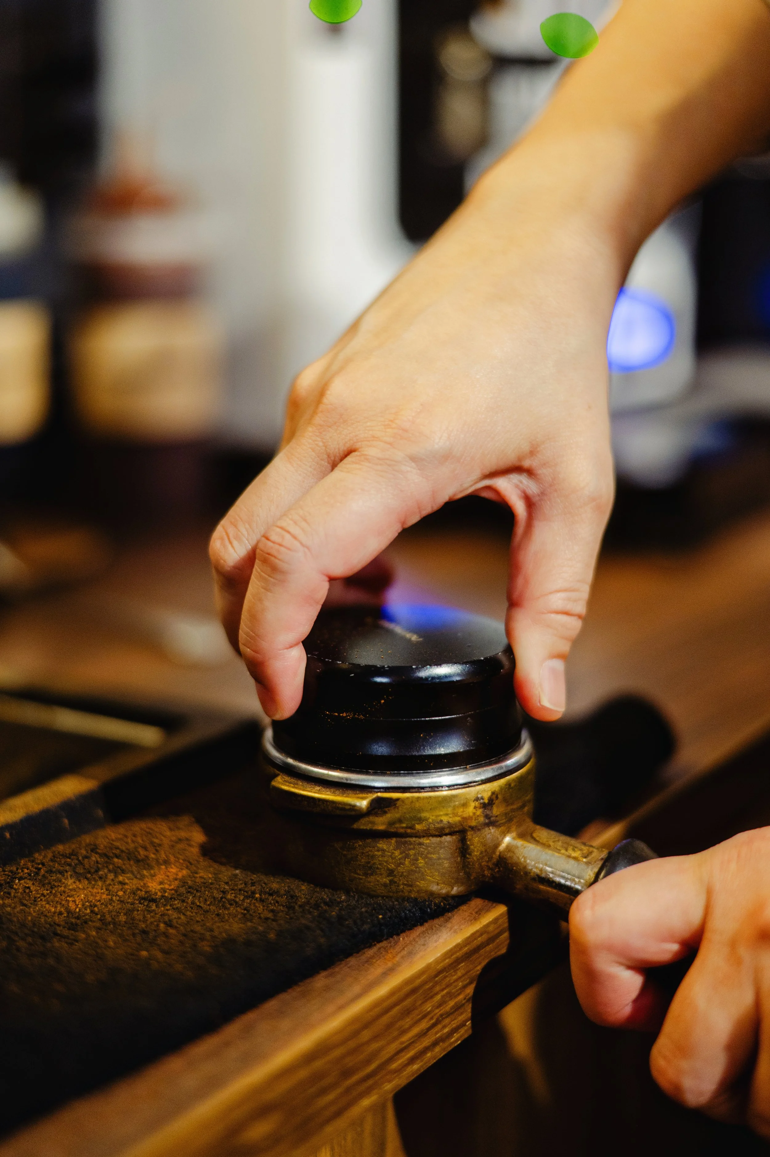 Photo of barista leveling coffee grounds.