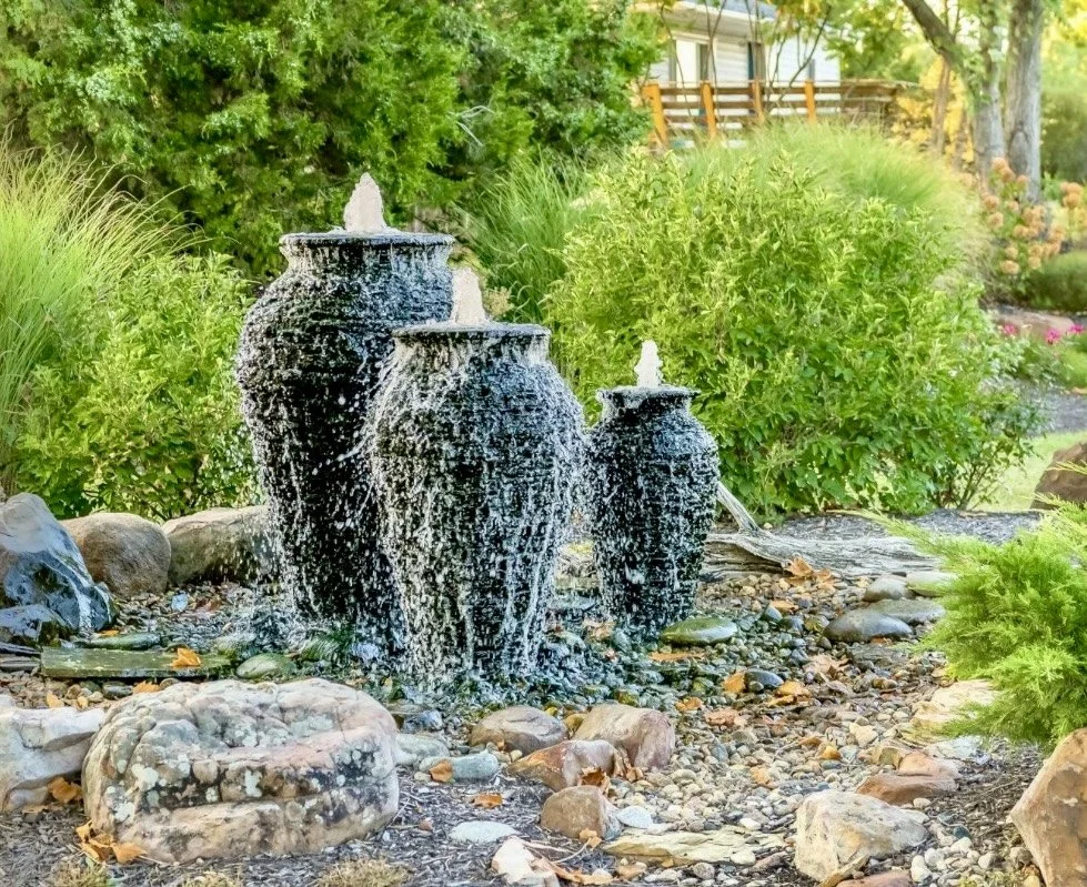 Custom water feature with cascading urn fountains and pond installed by Greenspan Landscaping Company in Black Mountain, NC