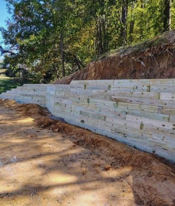 Back angel of timber retaining wall service completed by Greenspan Landscaping Company in Black Mountain, NC.