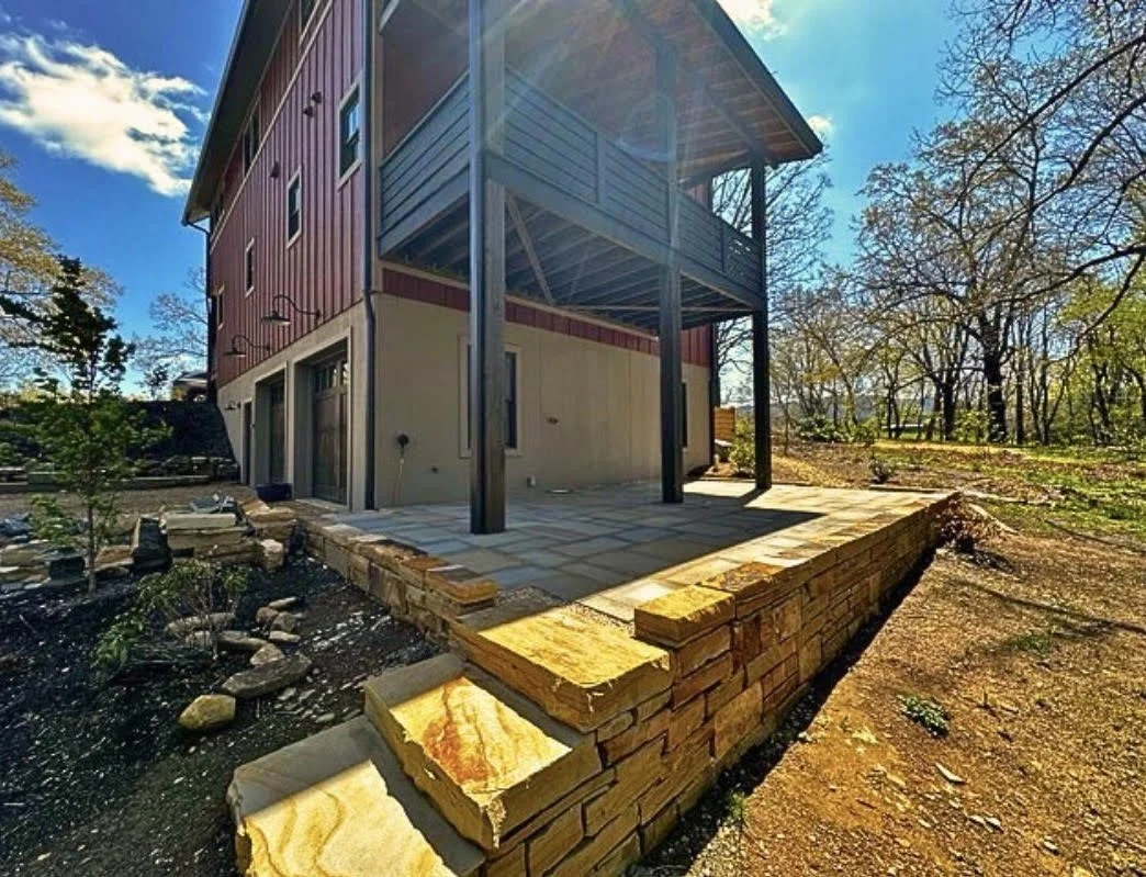 Retaining wall construction with natural stone blocks and patio installation by Greenspan Landscaping Company in Asheville NC