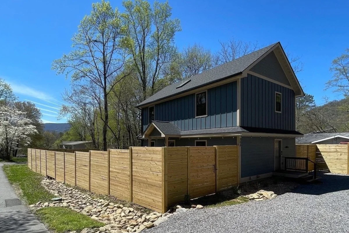Horizontal wood privacy fence installation around a residential property in Asheville, North Carolina.