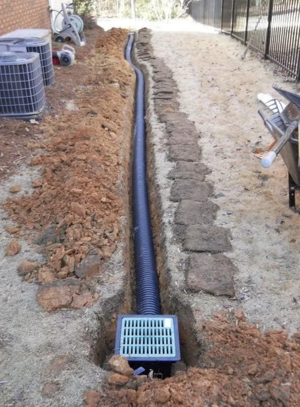 French drain and trench drainage installation to control runoff on a slide property in Black Mountain, NC