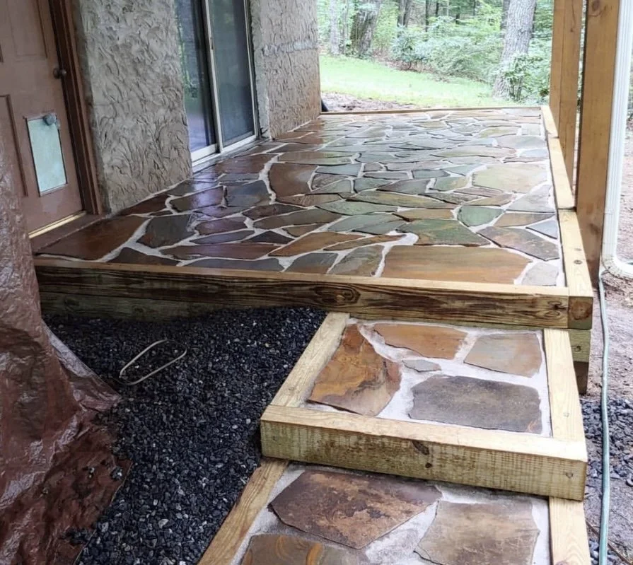 flagstone patio with timber step built for outdoor living by Greenspan Landscaping Company in Montreat, NC