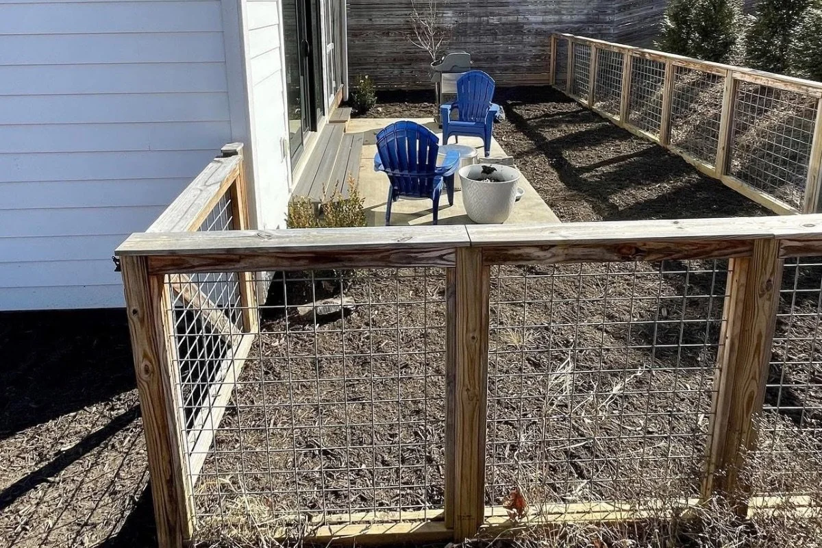 Wood frame hog wire fence installation around backyard patio in Montreat, North Carolina.