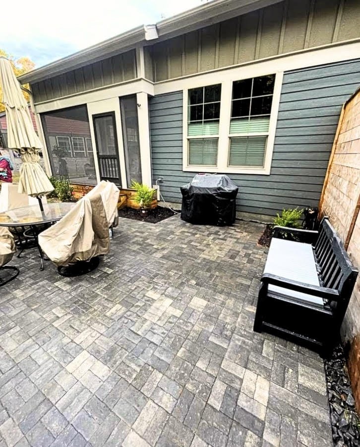 A backyard patio with interlocking concrete pavers in a herringbone pattern in Black Mountain, NC.