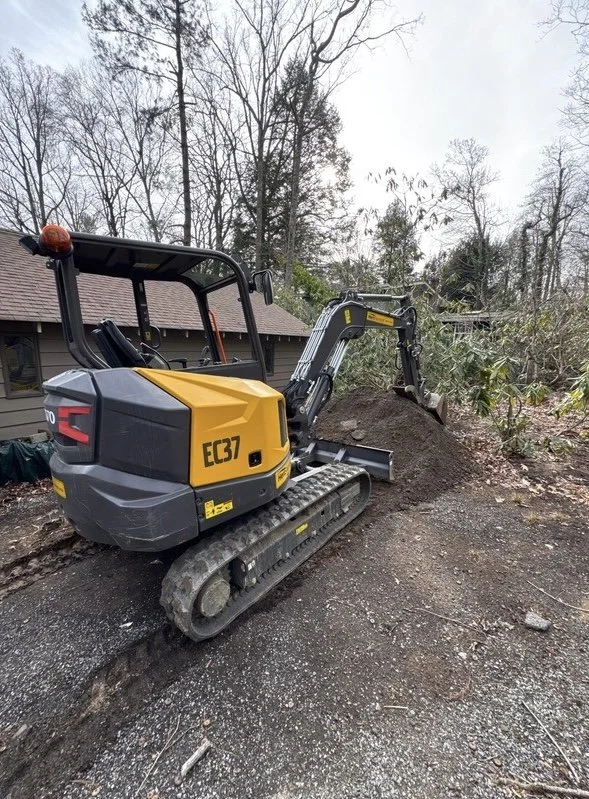 Erosion control and winter drainage work on a sloped residential property in the mountains of Western North Carolina