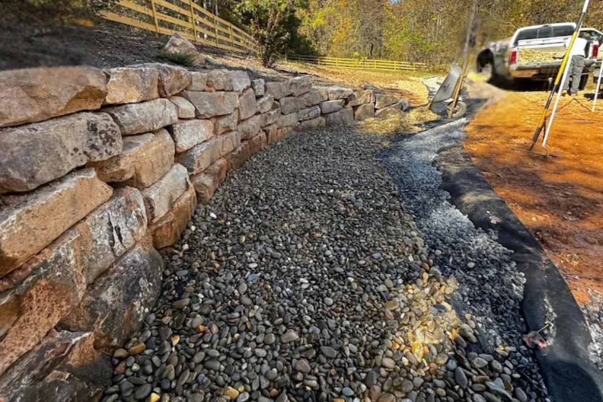 Natural boulder retaining wall stabilizing hillside property in Western North Carolina