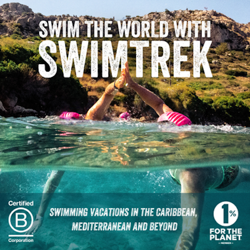 A person wearing pink swim caps doing a high-five underwater during a swimtrek holiday vacation in a natural water setting with hills and greenery in the background.