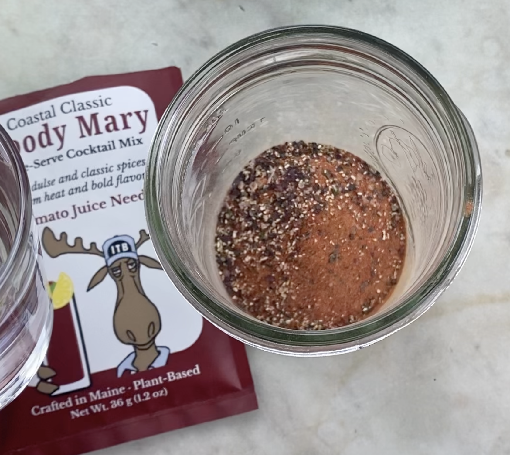 Bloody Mix in Jar with empty packet and water.png