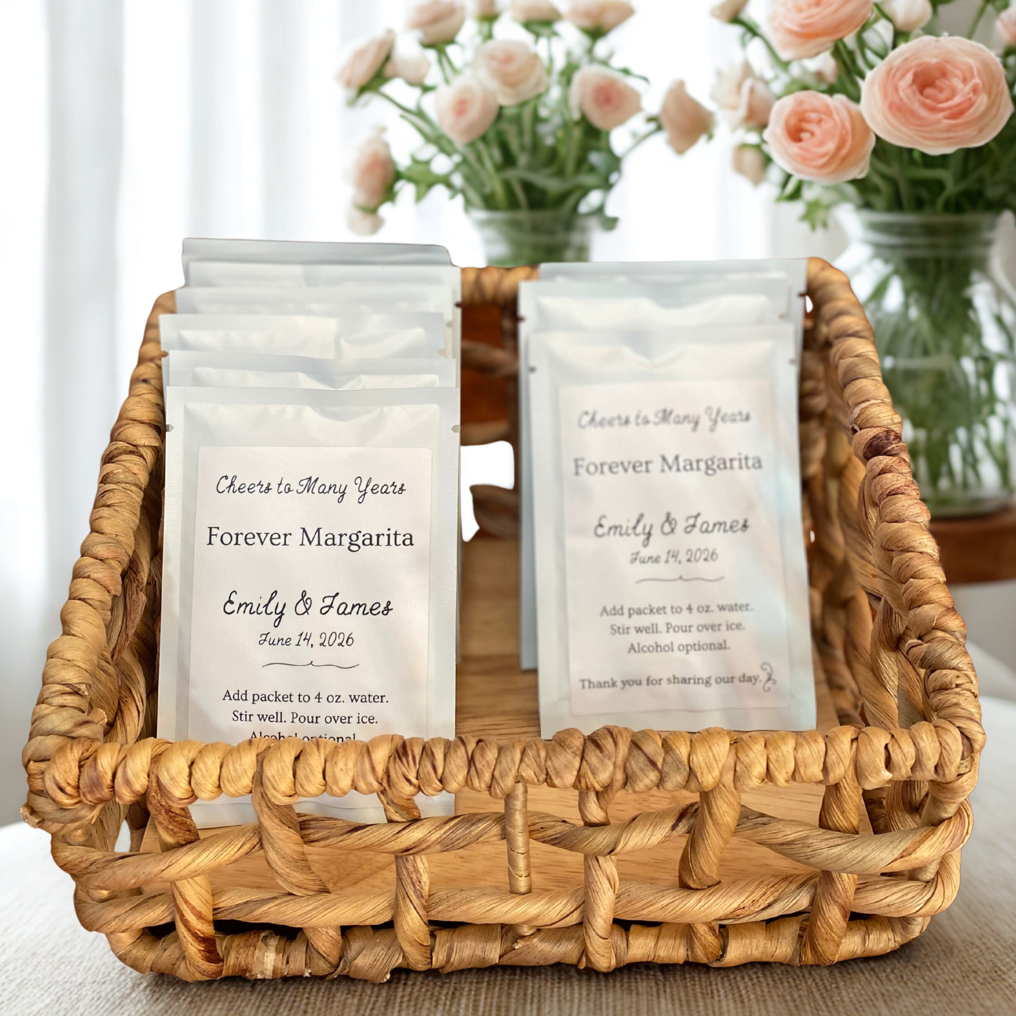 A basket containing packets of Margarita, Daiquiri, Bloody Mary mix for guest thank you favors and floral arrangements in the background.