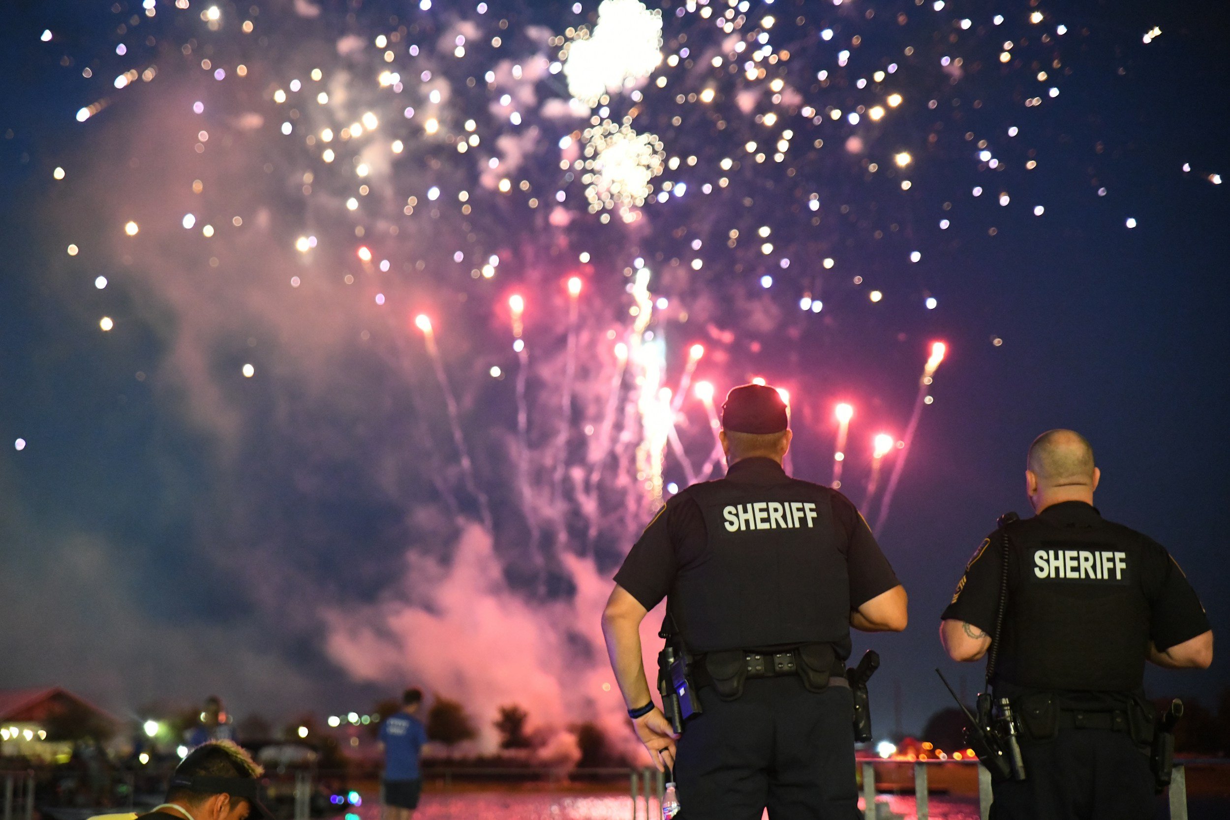 Sheriff deputies monitoring a July 4 fireworks crowd, illustrating the law enforcement planning challenges analyzed in Semper Incolumem's assessment of the 2026 holiday mass casualty cluster