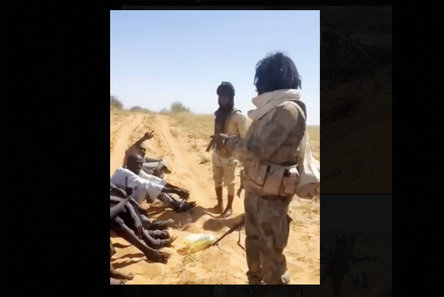 Armed RSF fighters standing near detained individuals in Darfur amid escalating violence and state collapse in Sudan